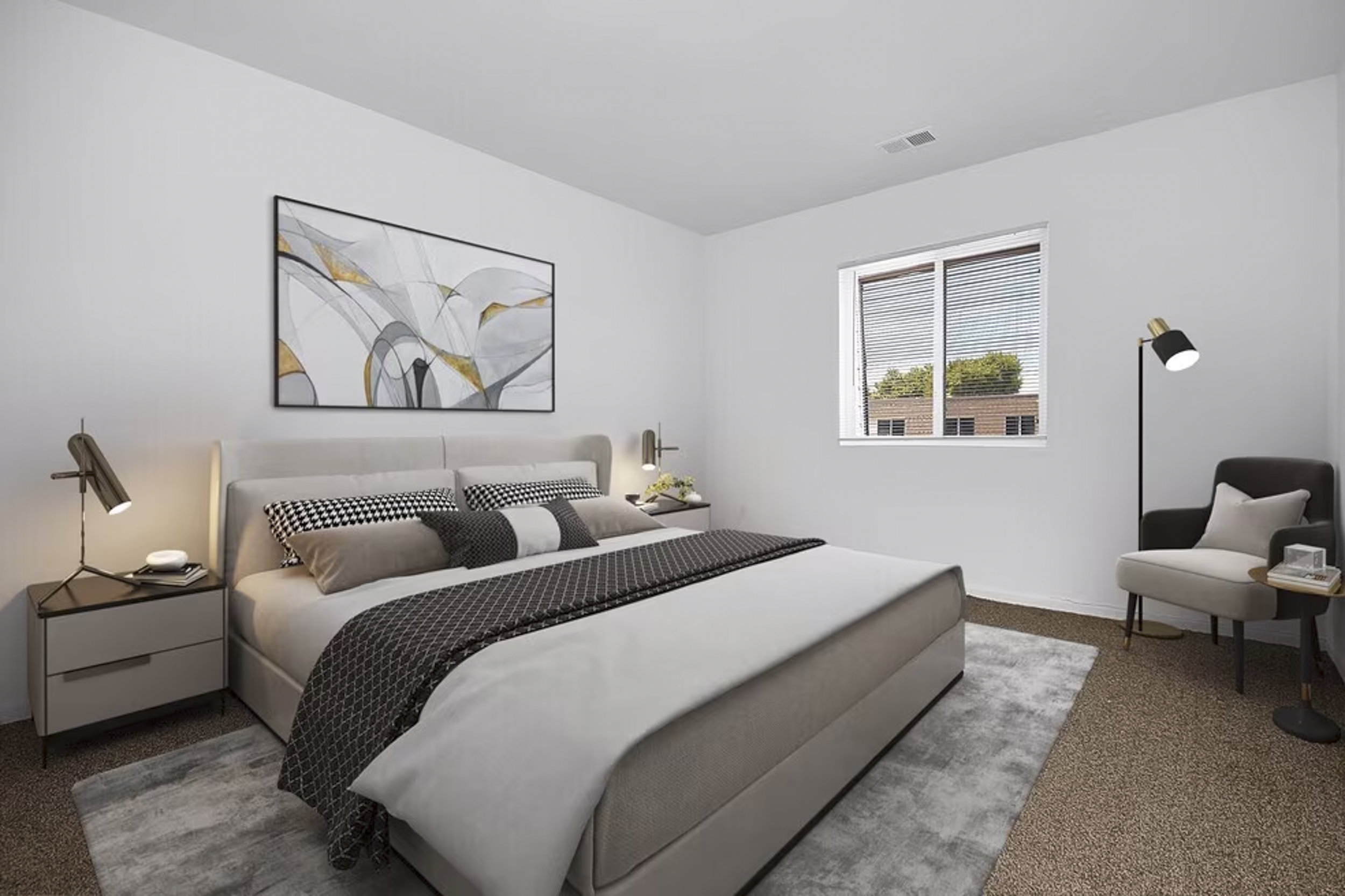 A modern bedroom with a large bed, abstract wall art, side tables with lamps, a chair with a cushion, and a window with blinds showing trees outside.