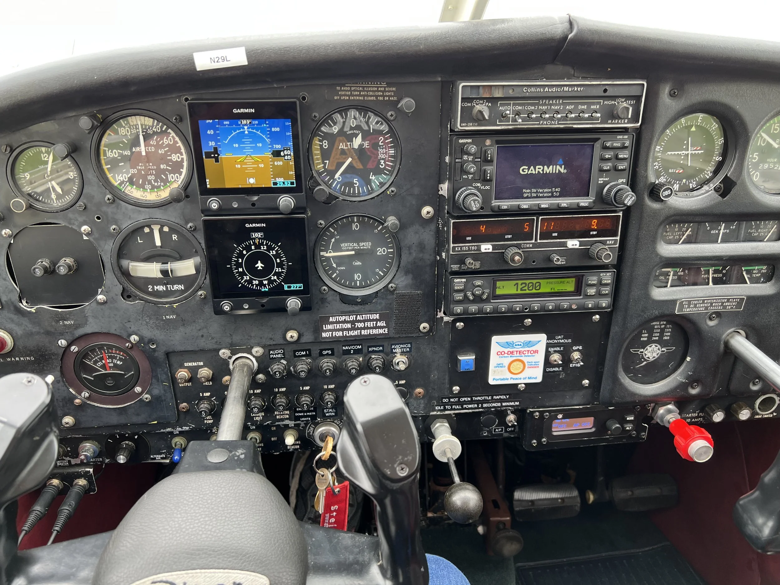 The cockpit of an airplane showing various gauges, switches, and electronic displays.