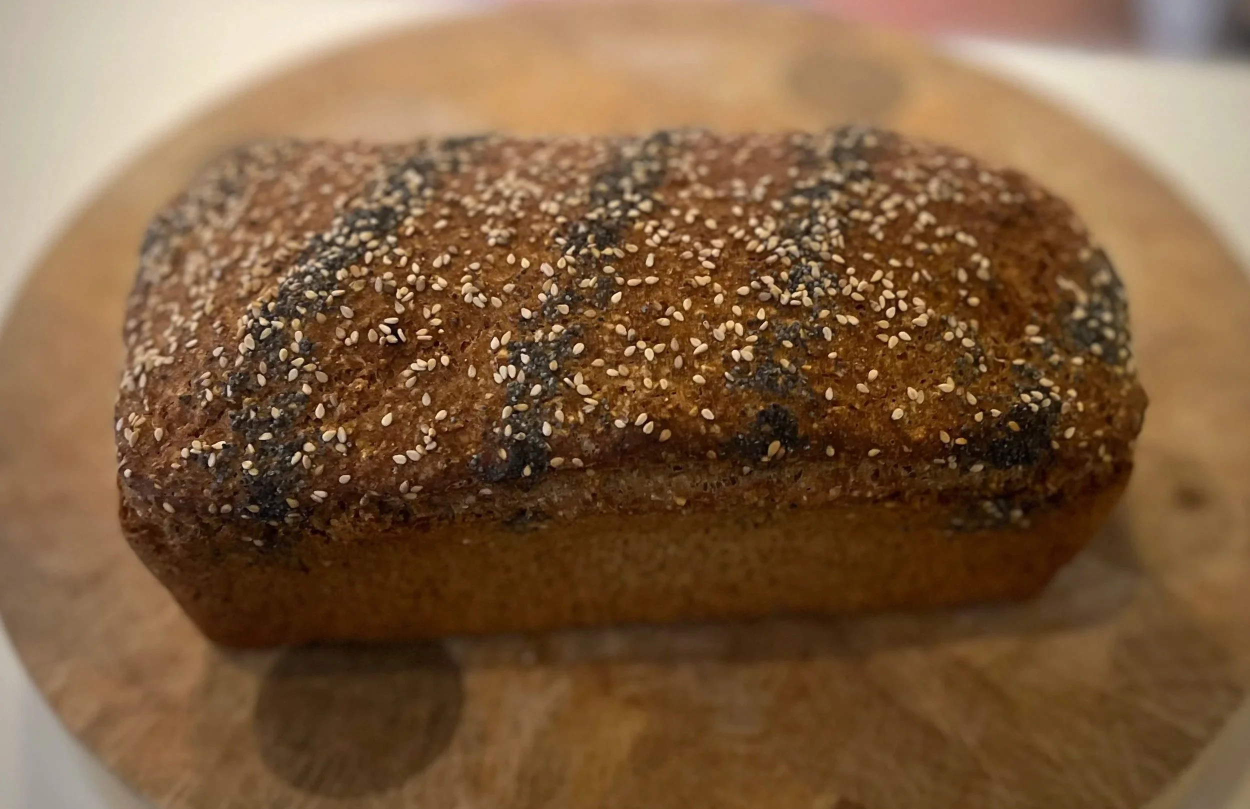 Brown yeast bread topped with poppy seed and sesame seeds