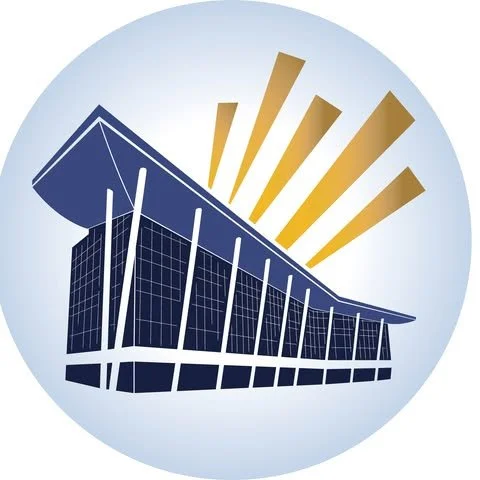 A modern building with large glass windows and an overhanging roof, with stylized sun rays in the background.