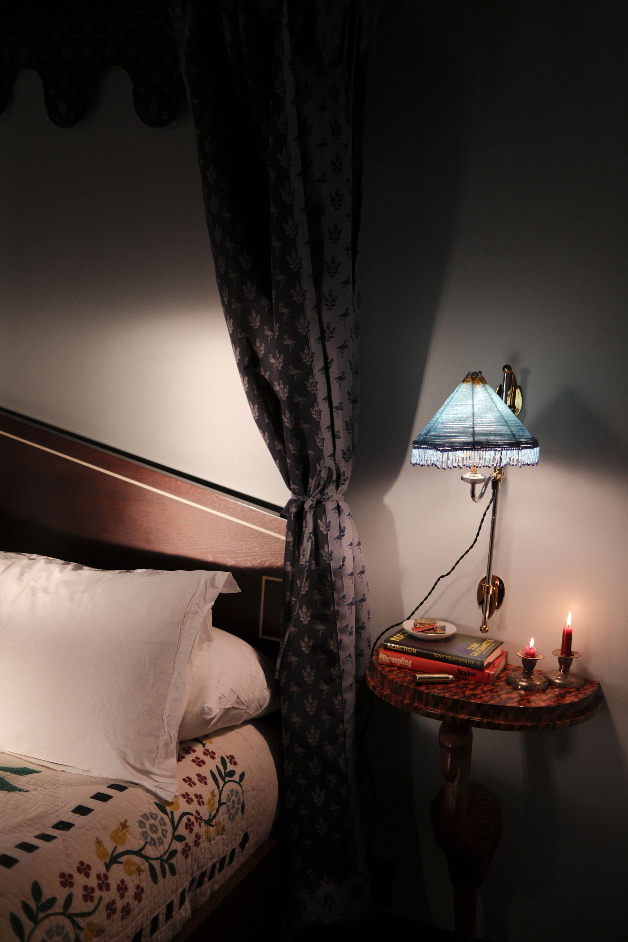 Dasher Suite bedside table with books and candles