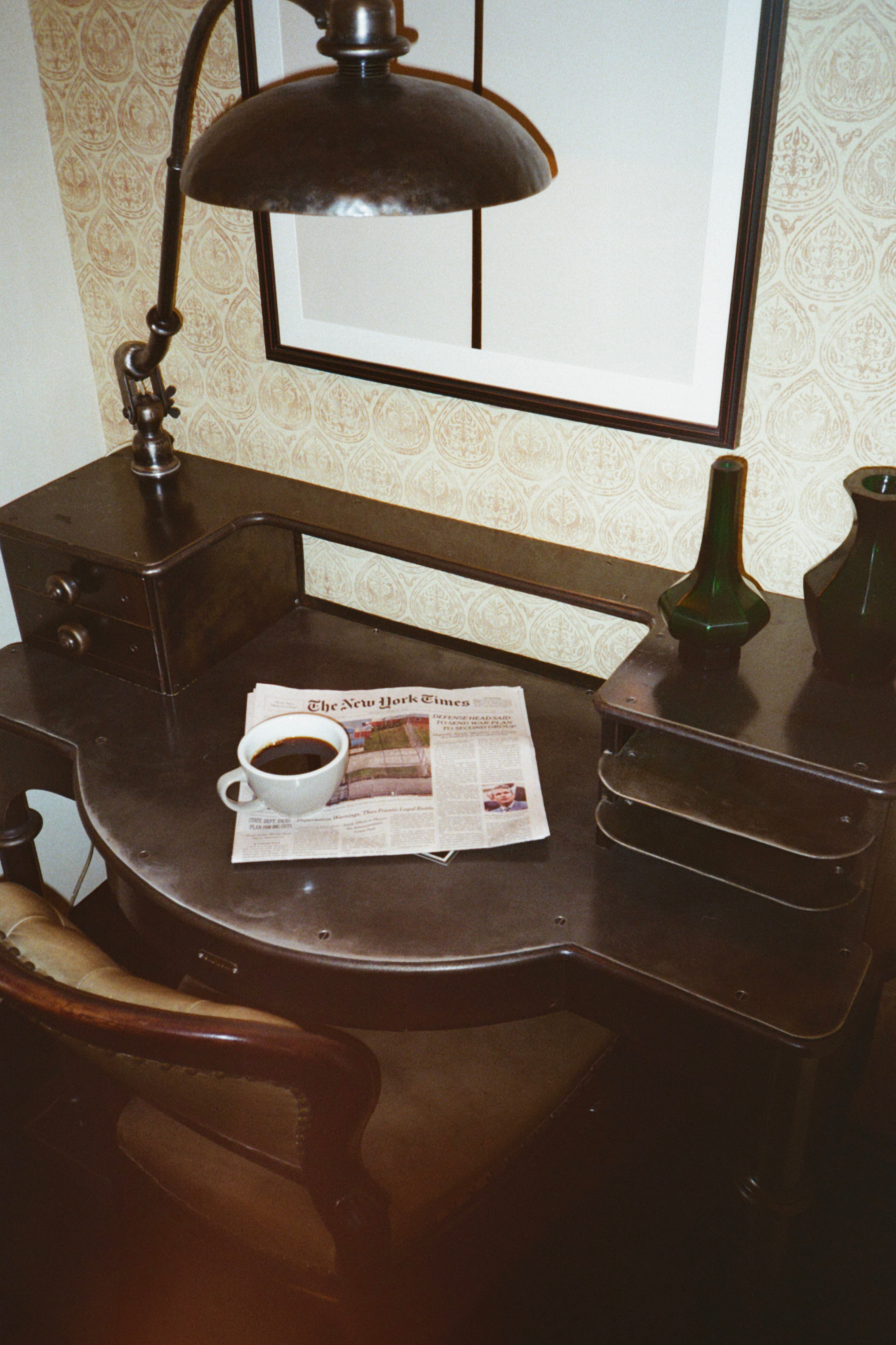 Coffee and newspaper on writing desk