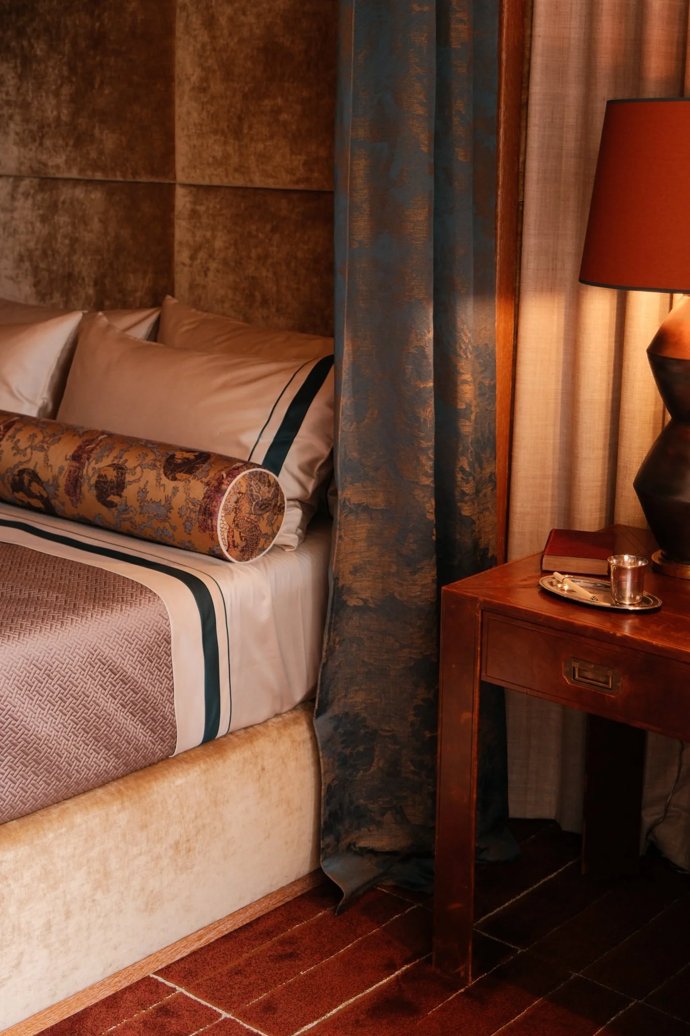 bed with drapery and a nightstand