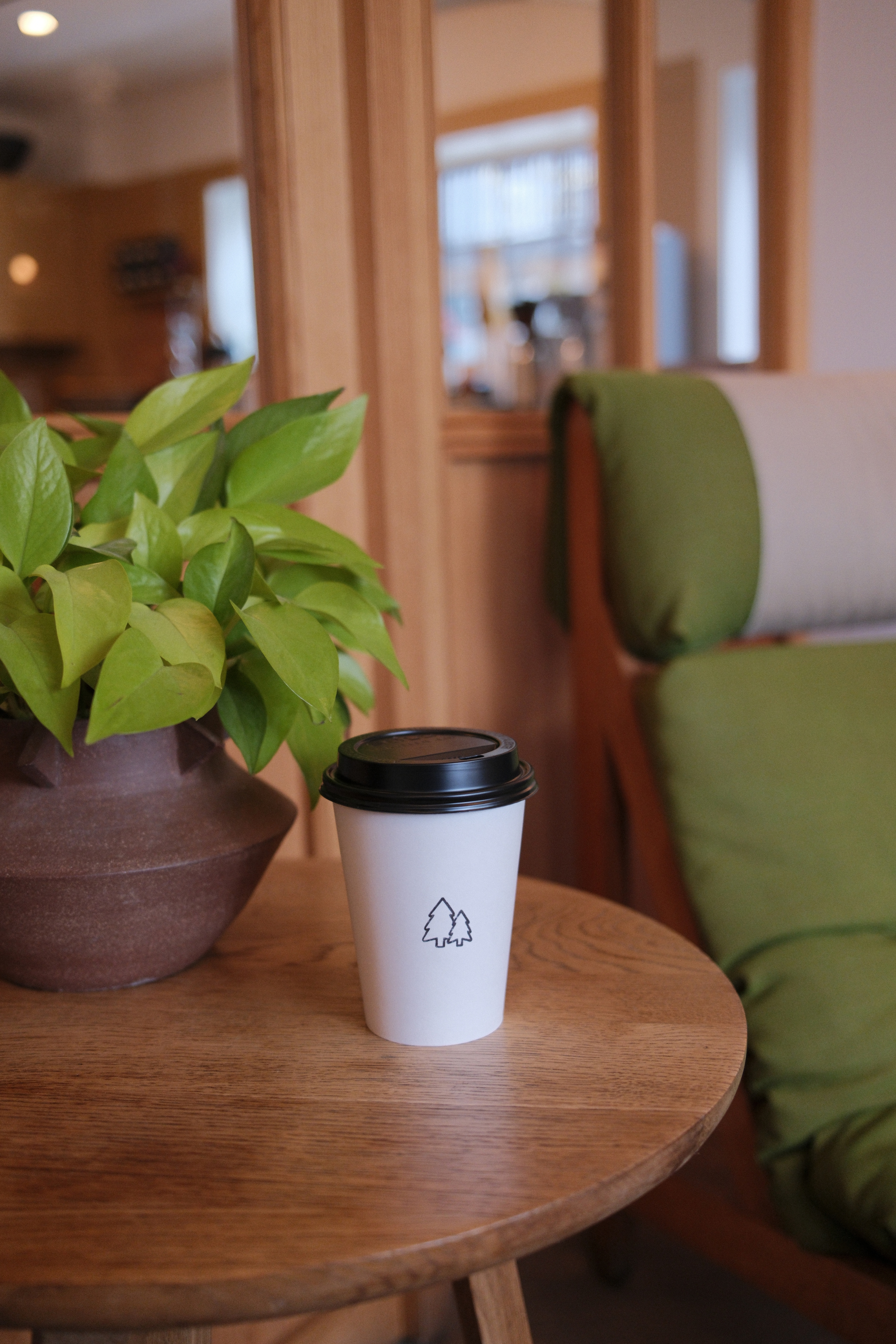 Branded coffee cup on a lobby side table