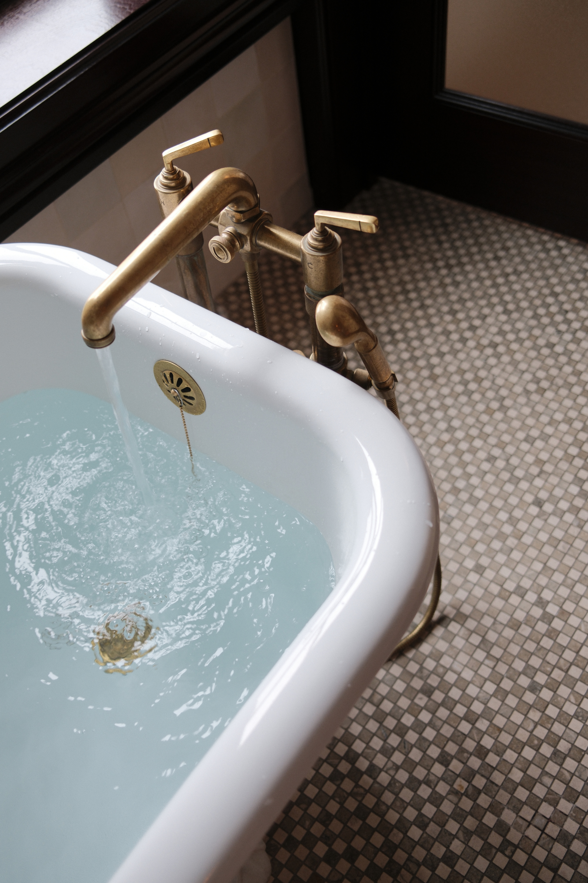 Bath filled with water with tile floor