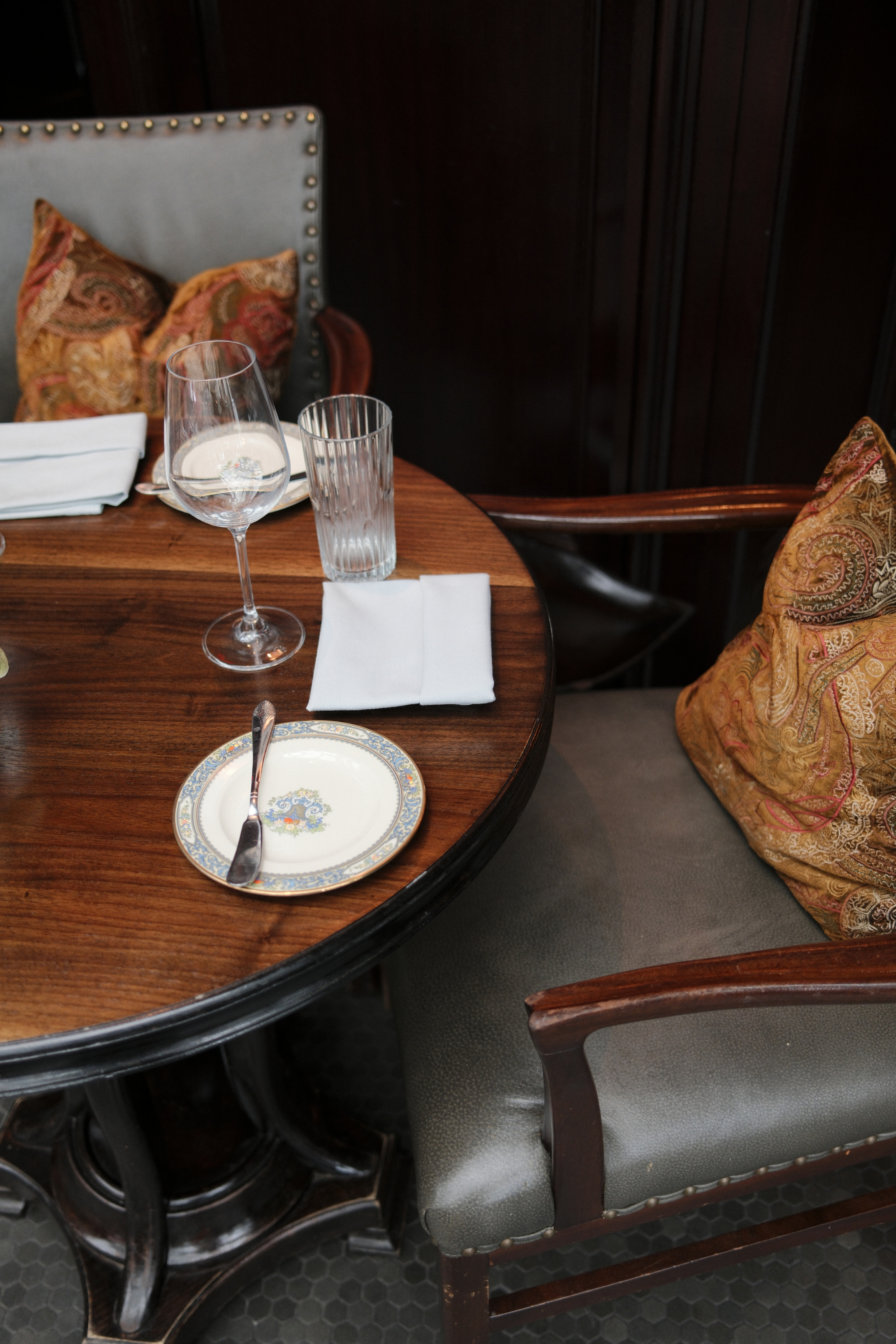 SERRE Restaurant seating with wooden table set with small plates and glasses