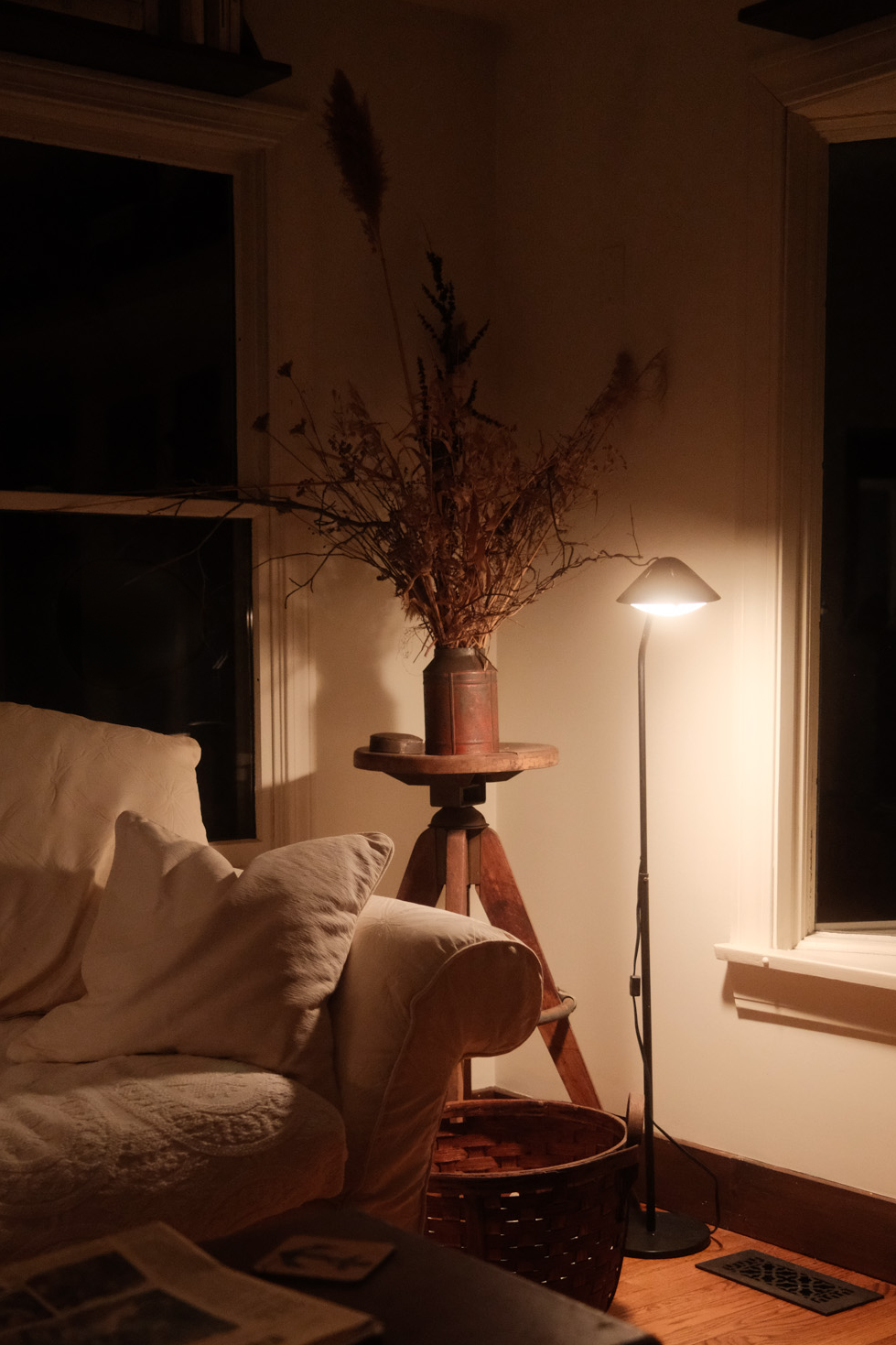 Living room at night with lit floor lamp