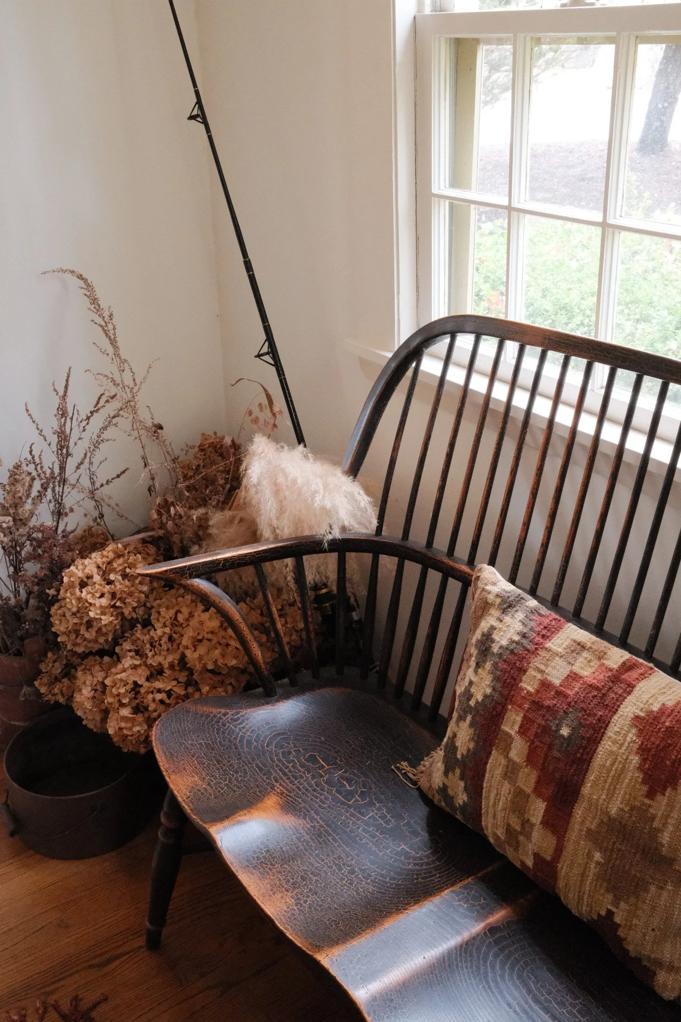 Bench with dried flowers and fishing pole