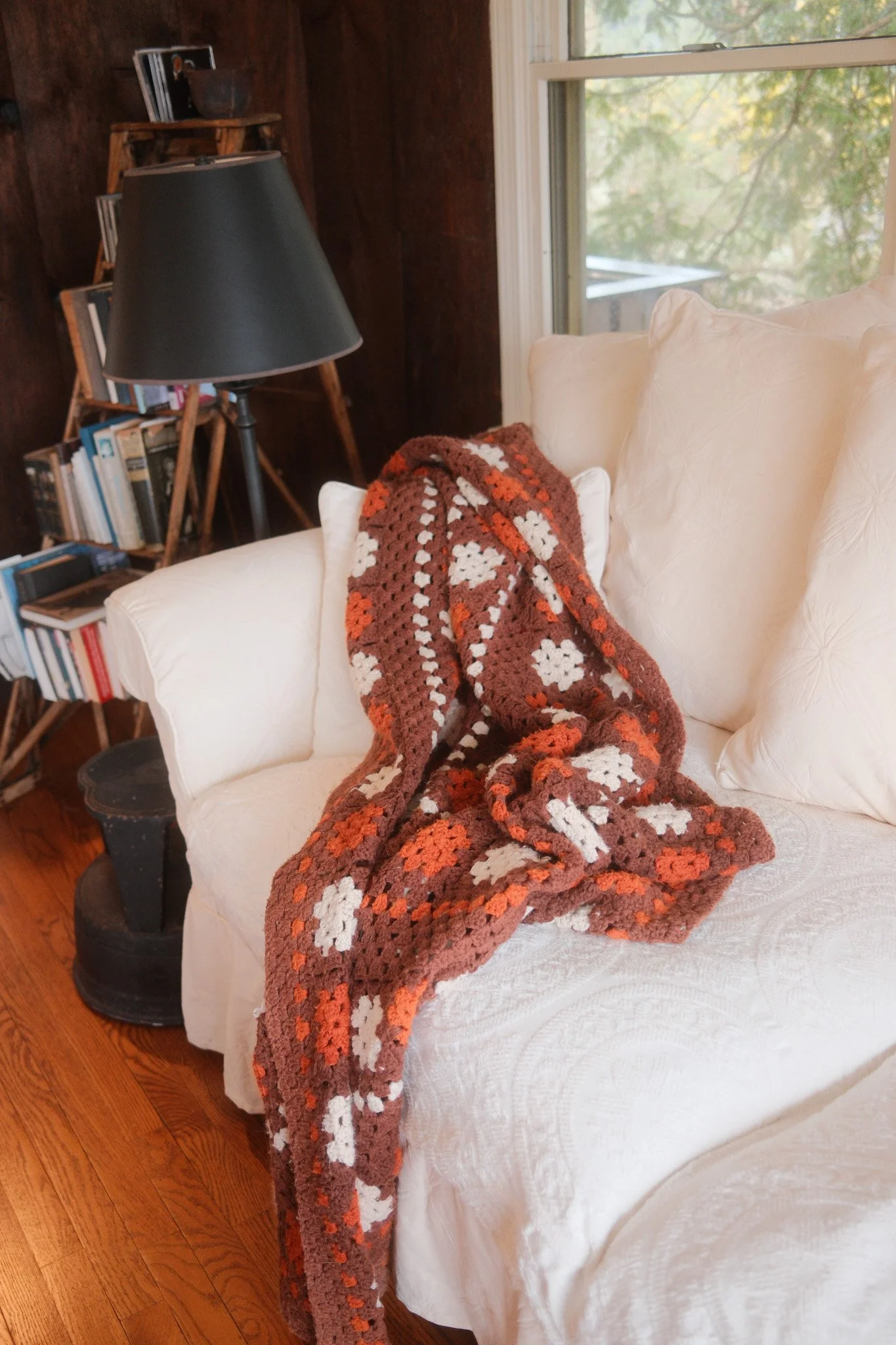 Couch with brown blanket