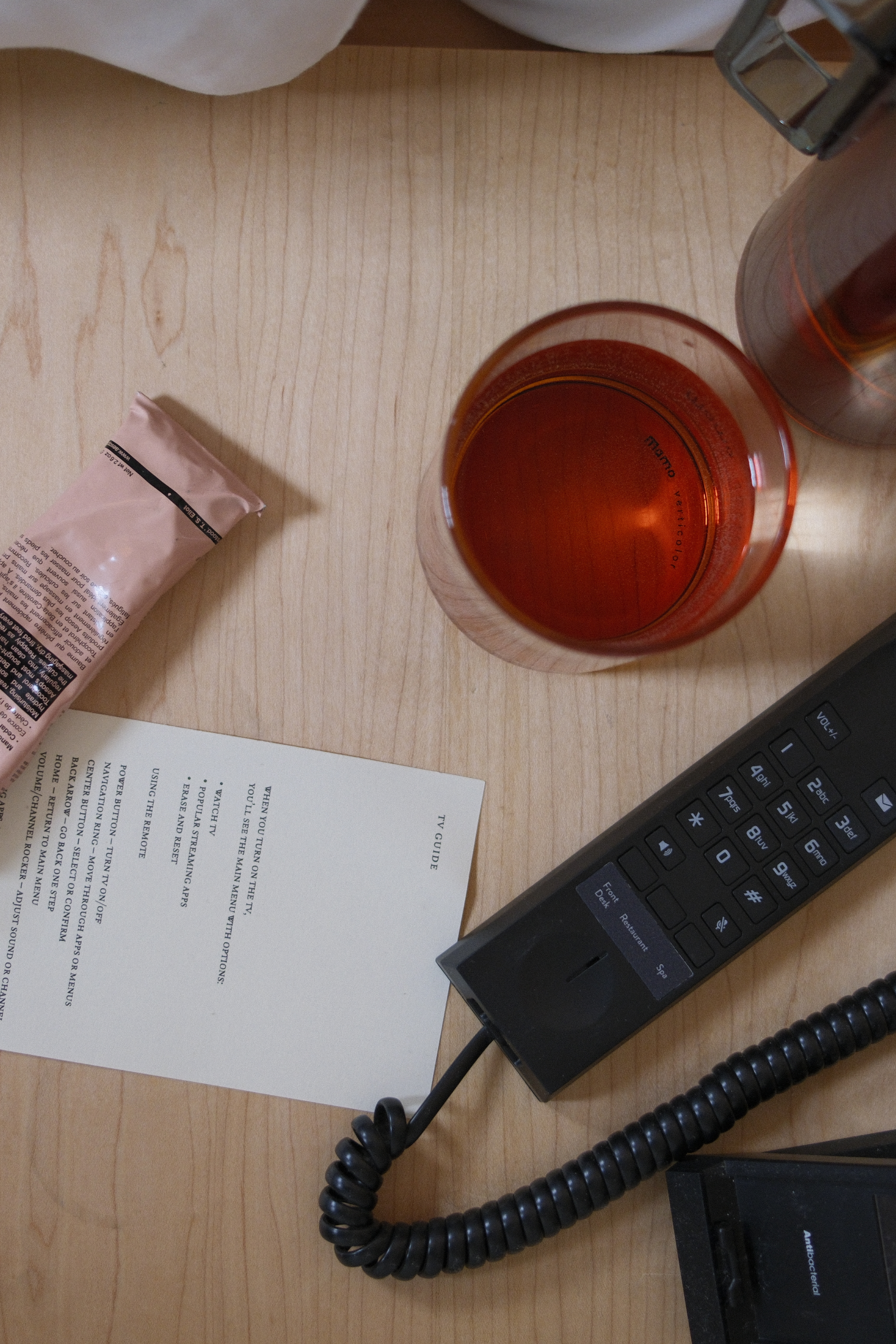 Bedside table with a water glass and phone