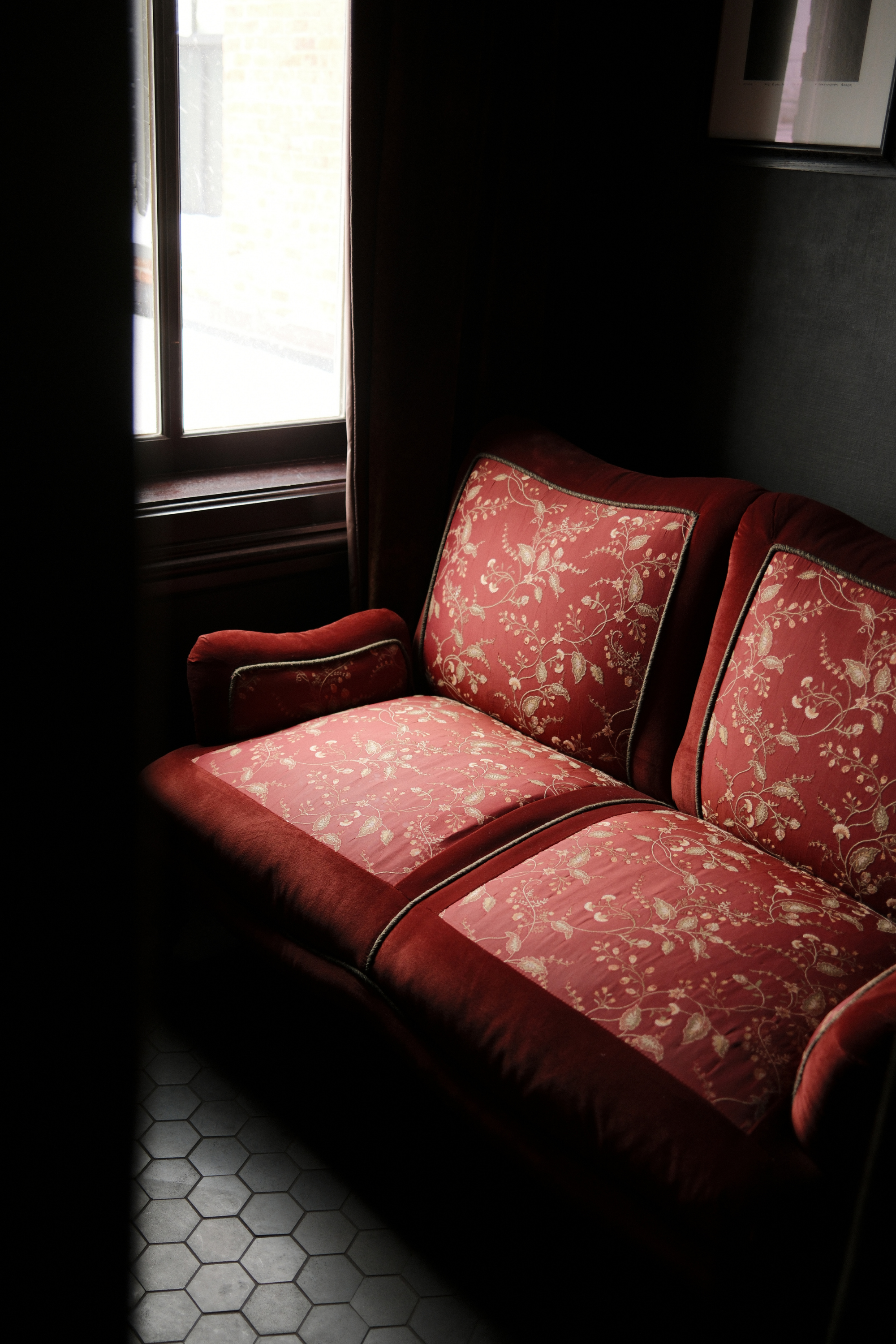 Red sofa next to window