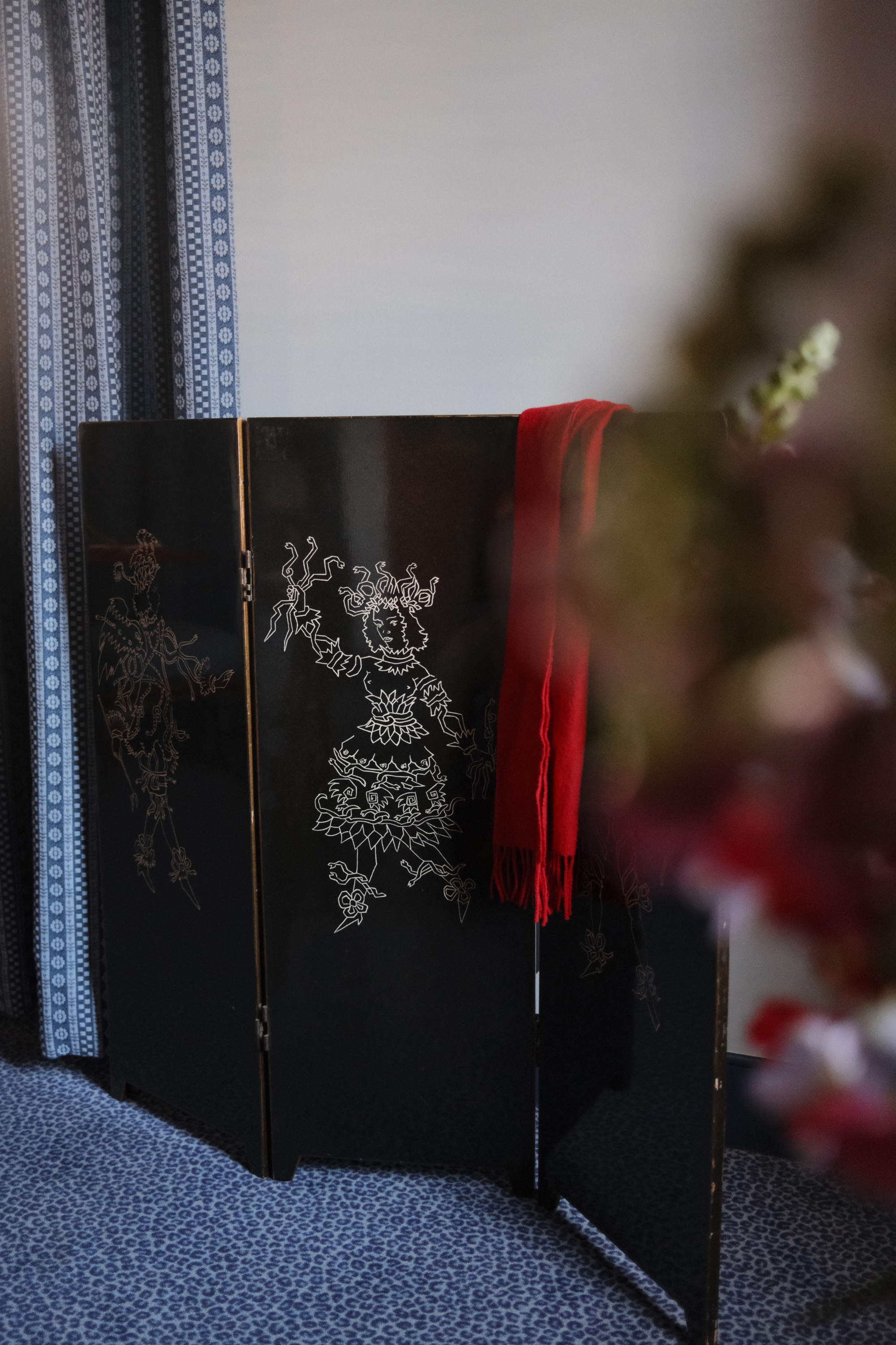 Decorative divider with red scarf