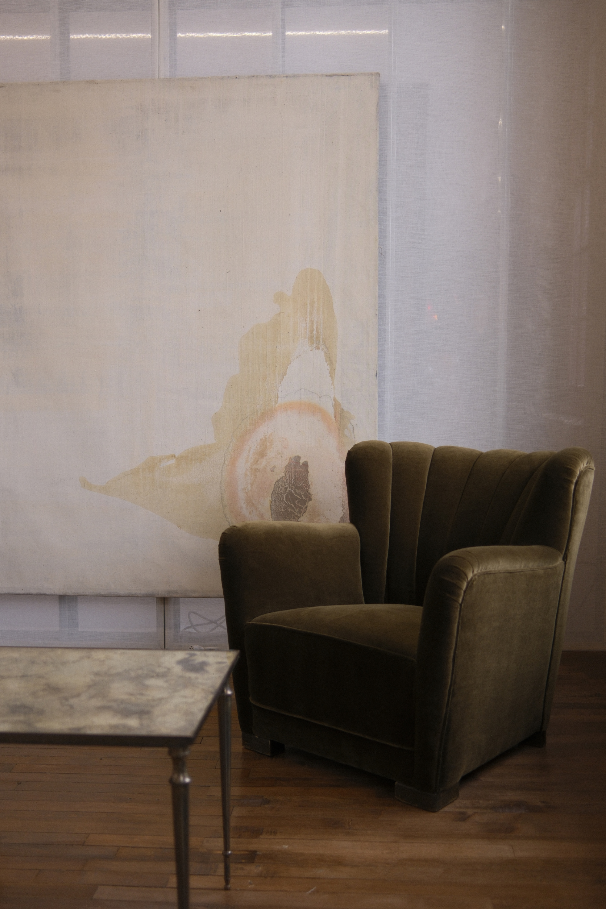 Green lounge chair and marble coffee table at Show:Room