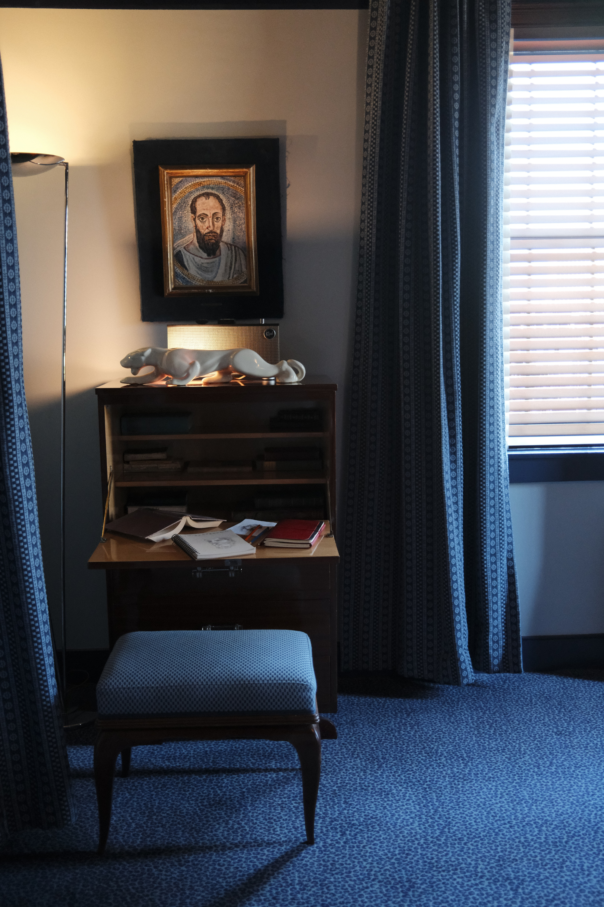 Dasher Suite writing desk with ottoman, floor lamp, and window