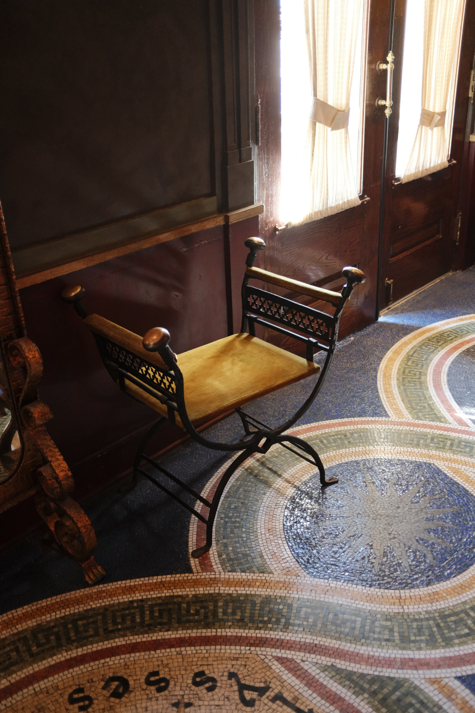 Hotel Ulysses lobby with yellow stool and mosaic floor