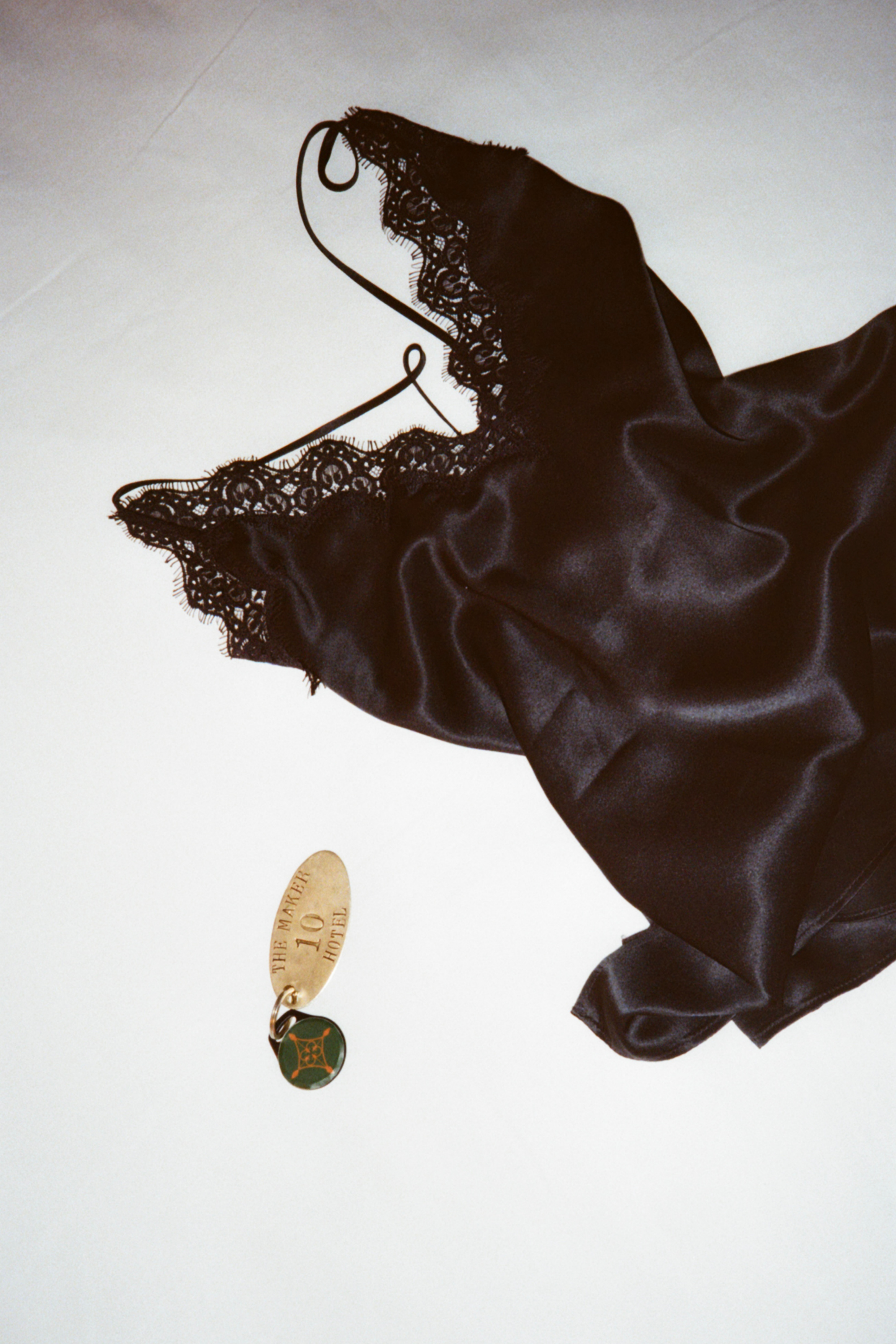 Black silk and lace women's top and room key