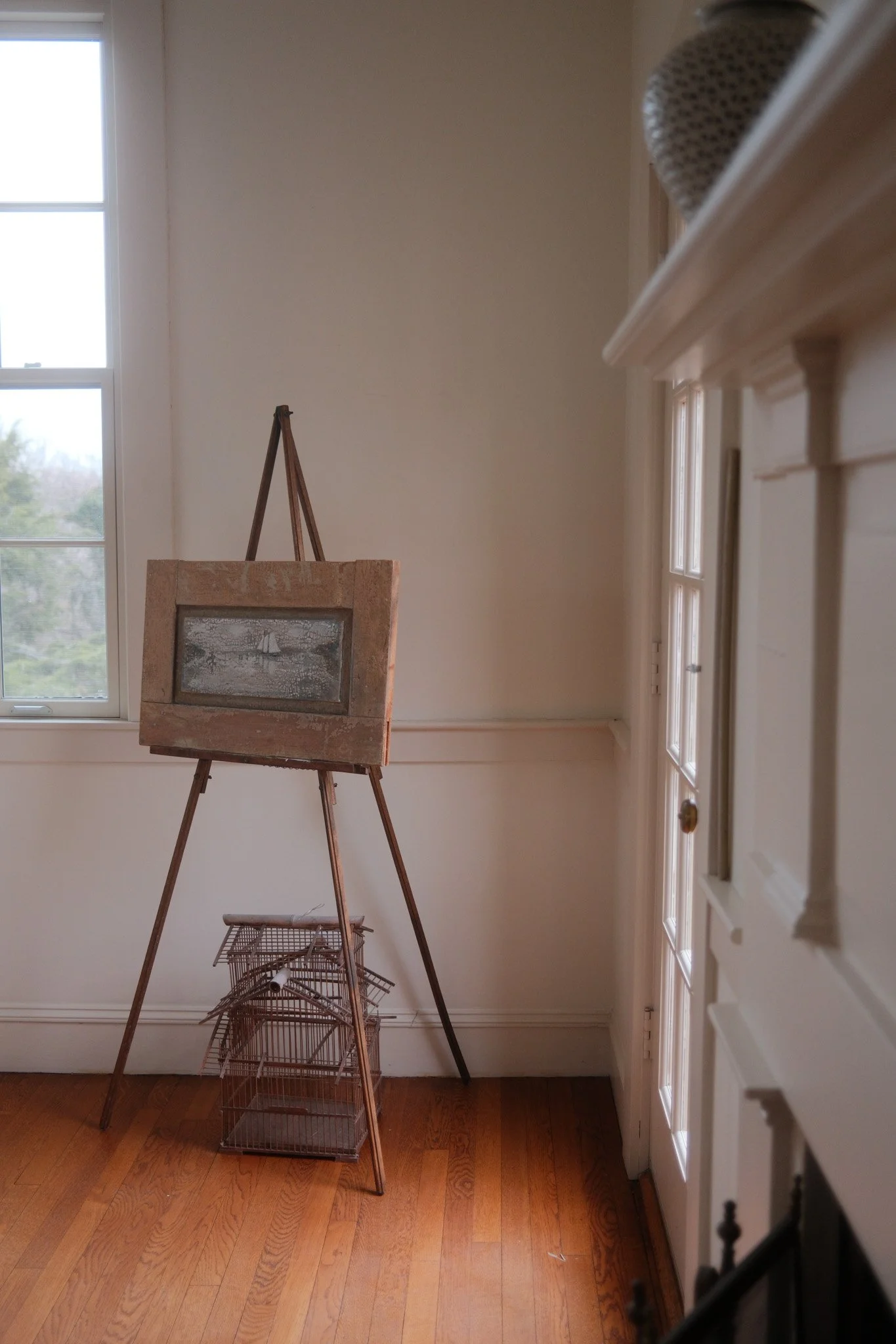 Framed painting on an easel with decor