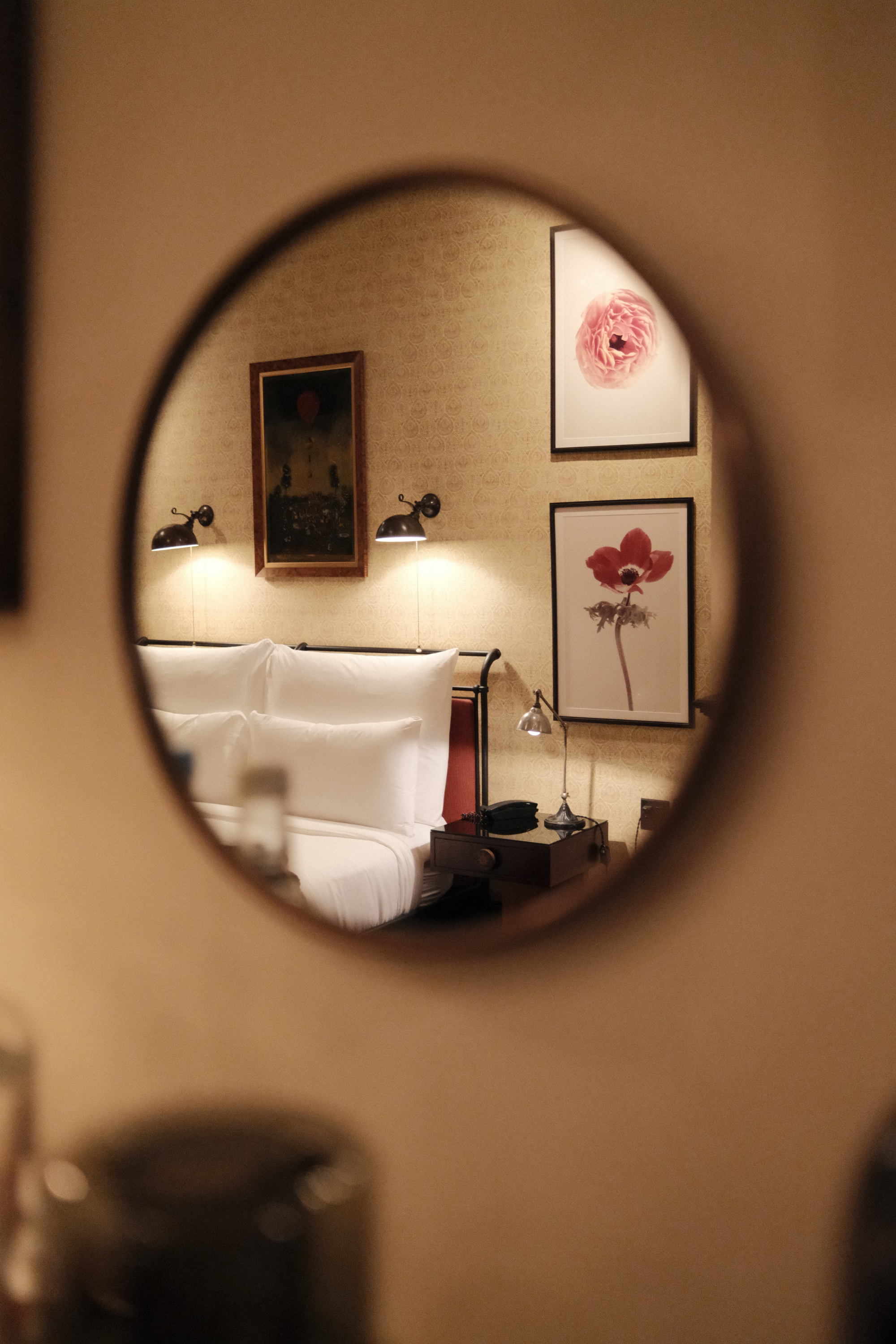 Reflection of the bed through a decor mirror