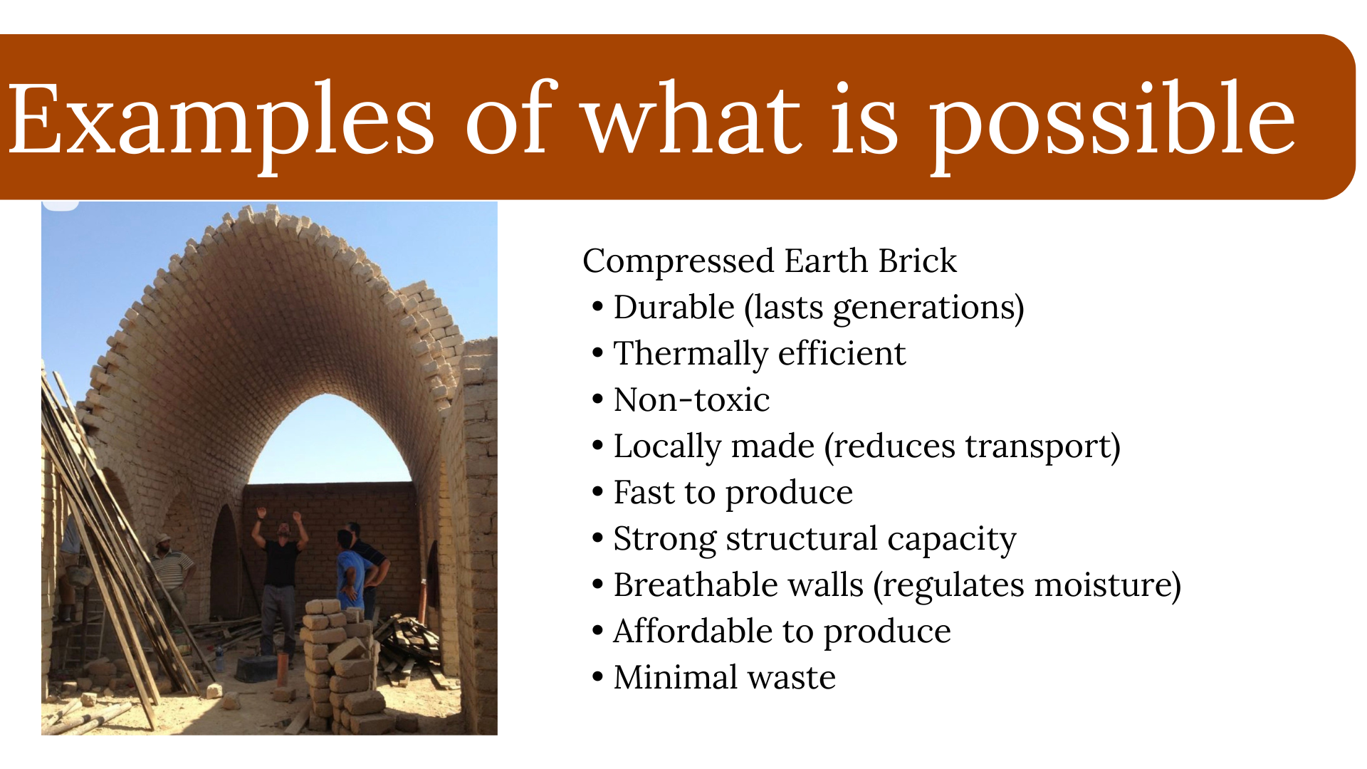 A construction site showcasing an arch made of compressed earth bricks, with workers and construction materials nearby, illustrating examples of sustainable building materials.