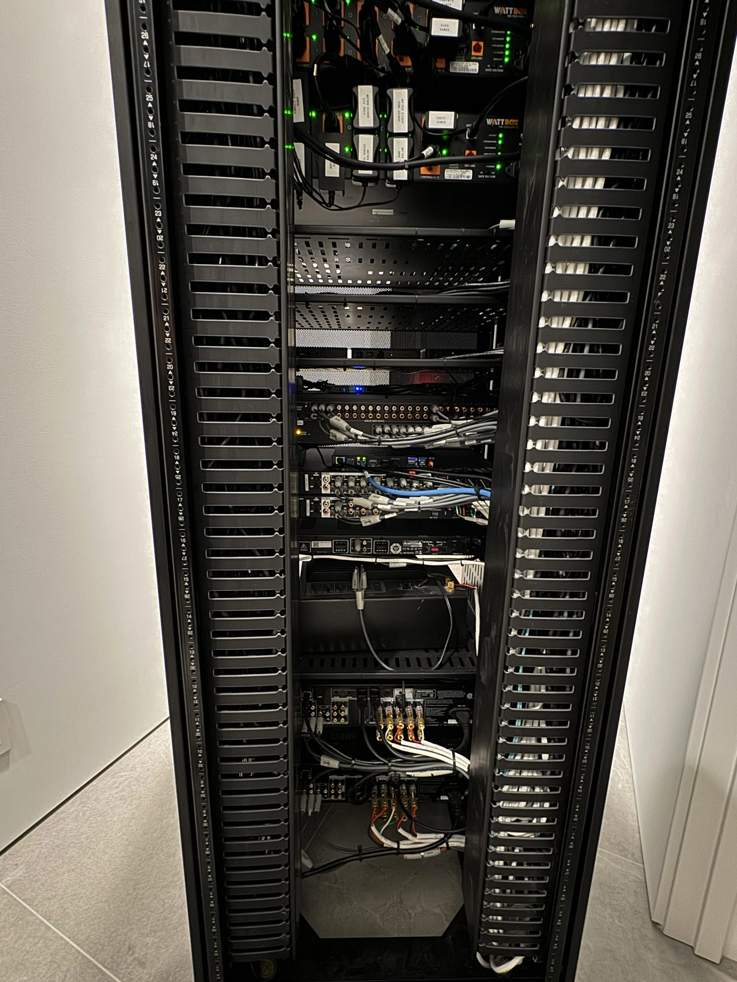 Inside a server rack with various electronic components and wiring.