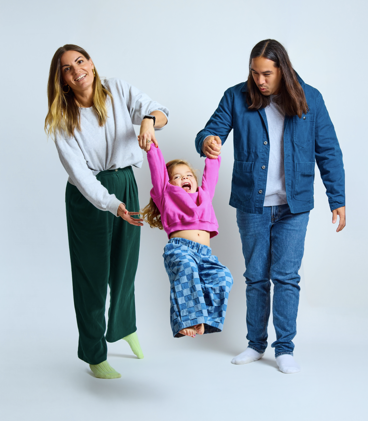 parents swinging laughing child during family portrait mini session Brooklyn NYC