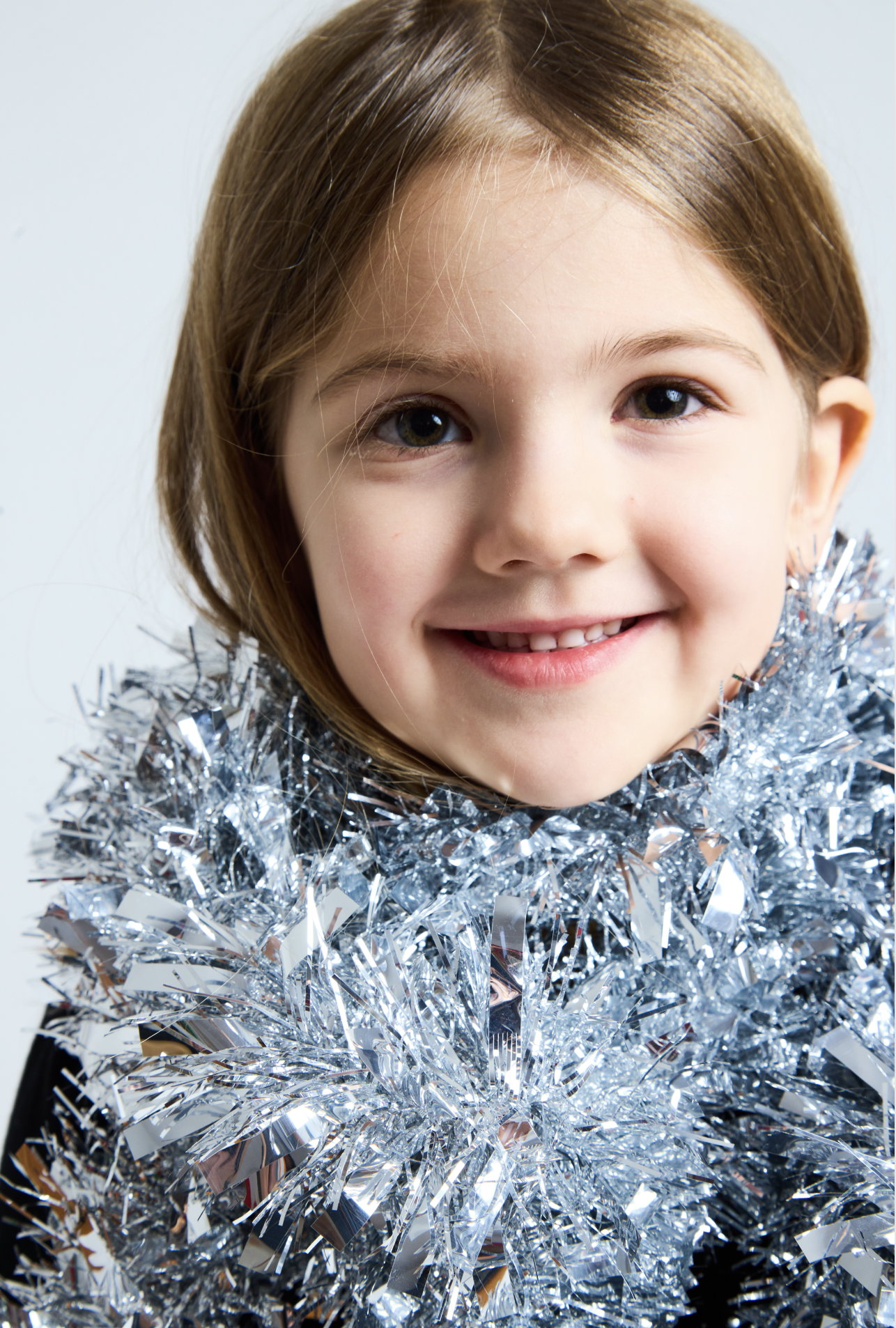 girl smiling close up with silver tinsel kids portrait photography Brooklyn