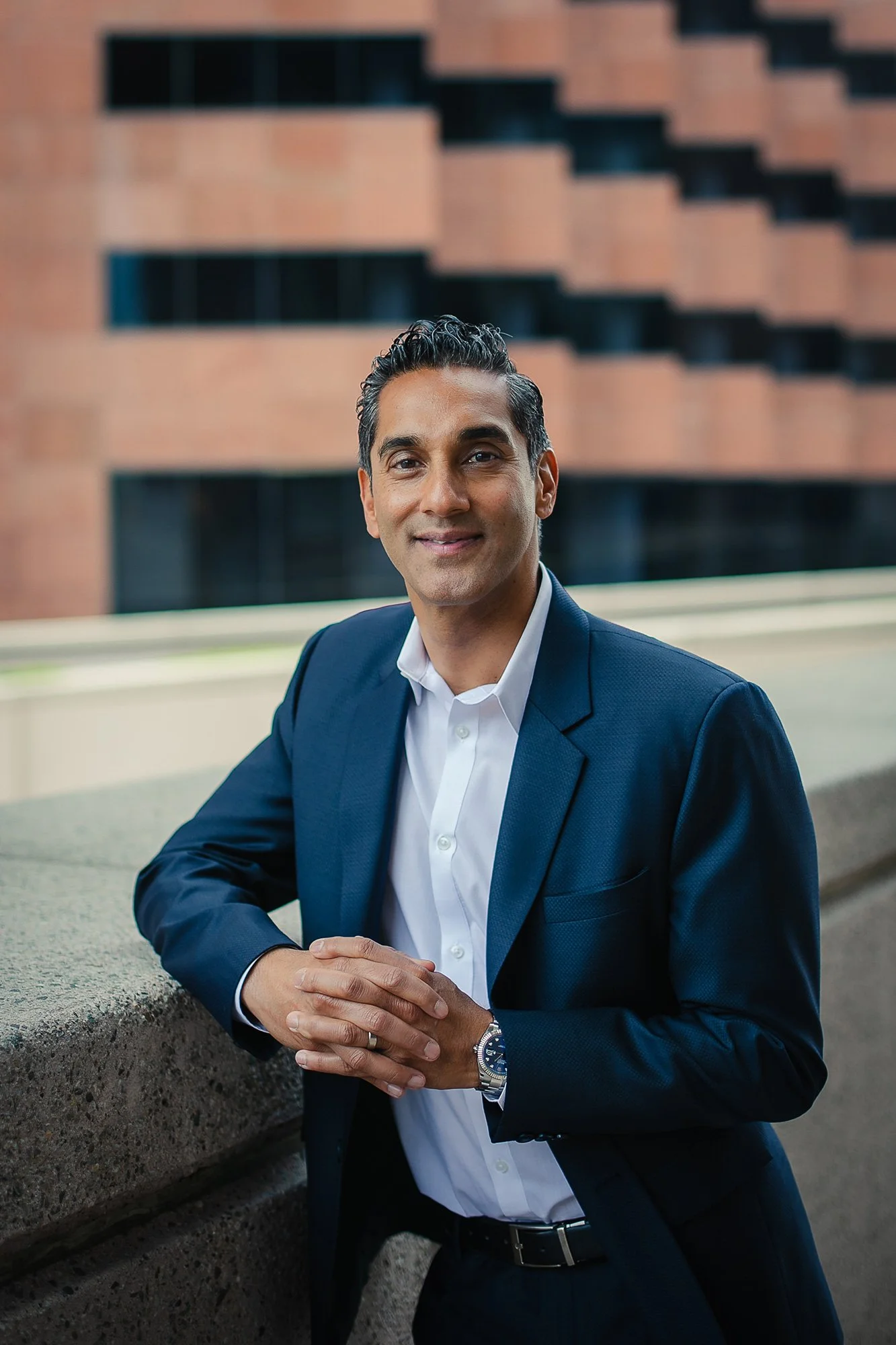 Lawyer in a suit standing with hands joined