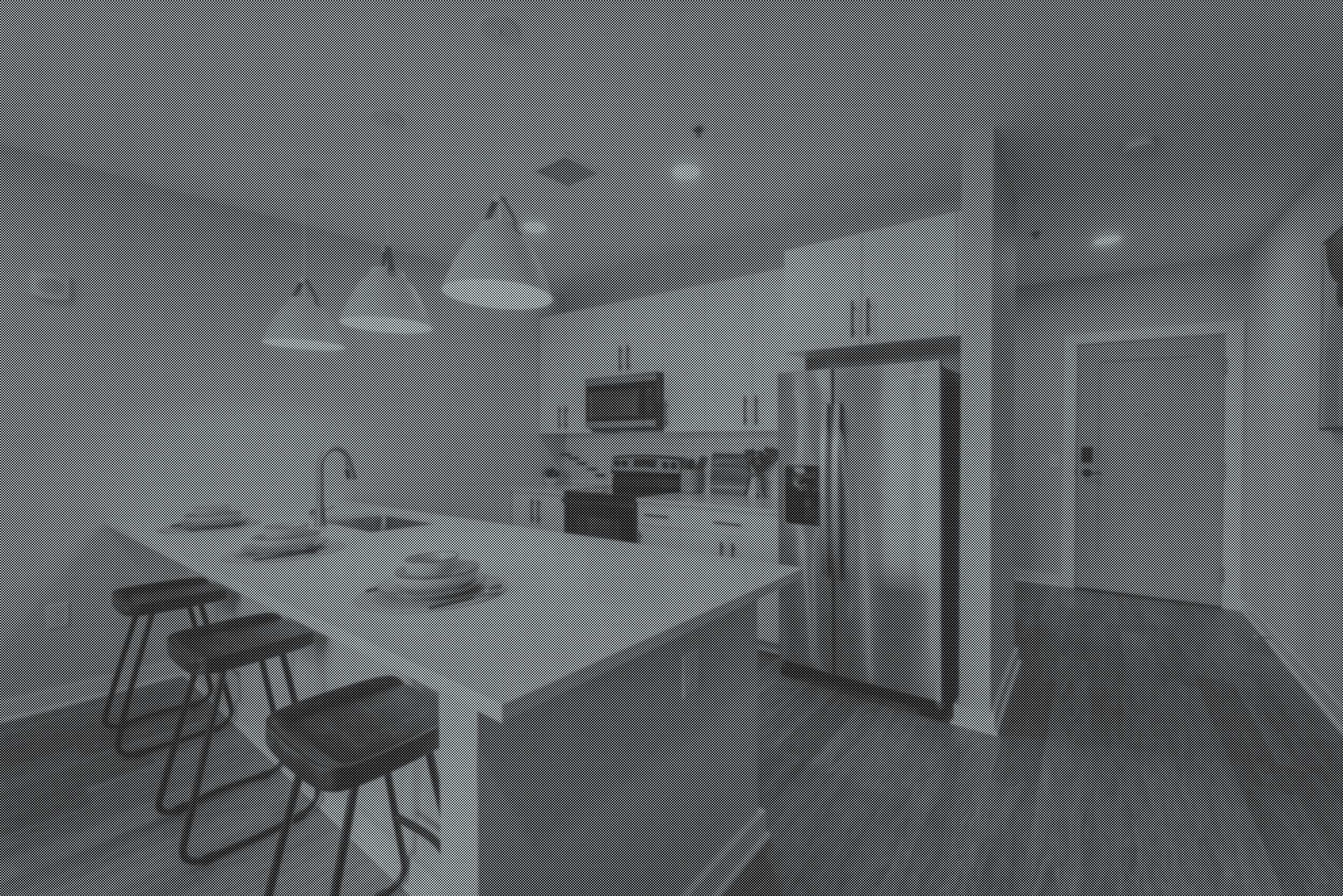 Modern kitchen with white countertops, dark cabinets, and a white tiled backsplash. There are four chairs around a small table, and pendant lights hanging from the ceiling.