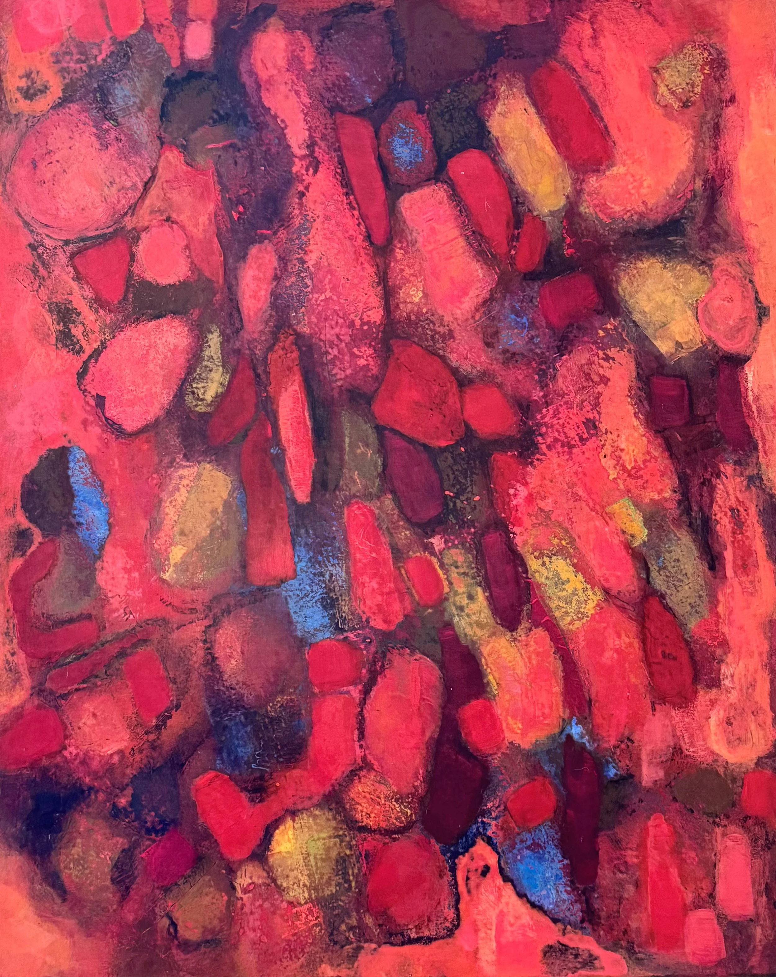 Abstract painting with textured, irregular oval shapes in shades of crimson, magenta, and coral with small accents of bright blue and yellow