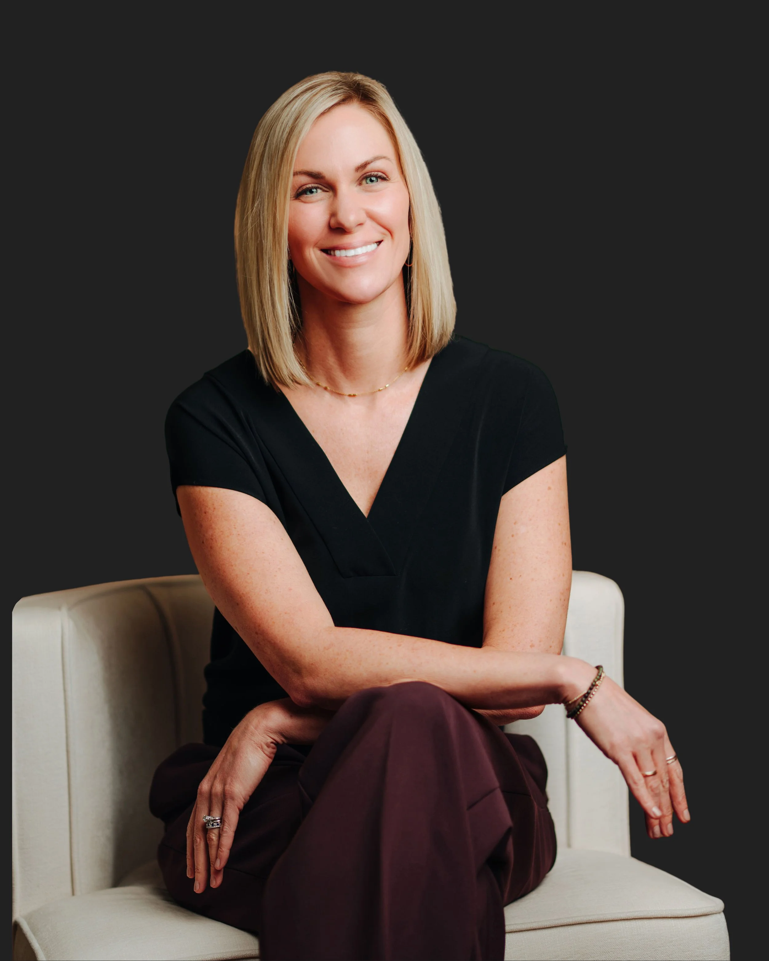 Lindsey Layne, founder of Ellevate Aperture, seated in studio portrait