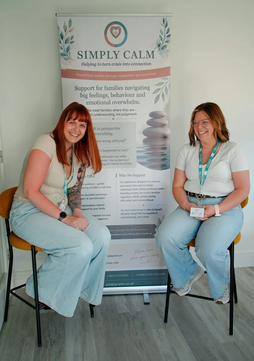 Alison and Carmen beside the Simply Calm banner