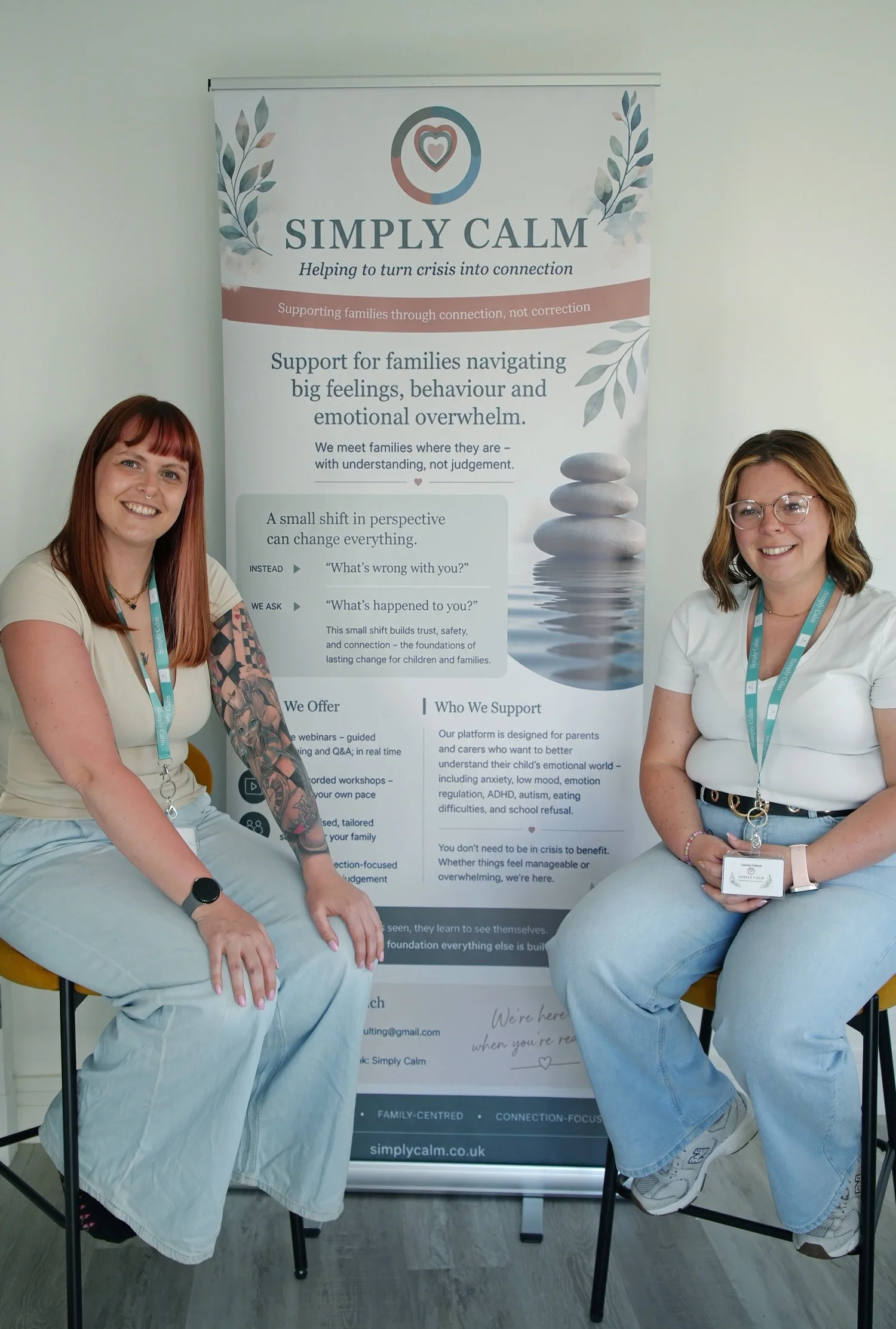 Alison and Carmen beside the Simply Calm banner