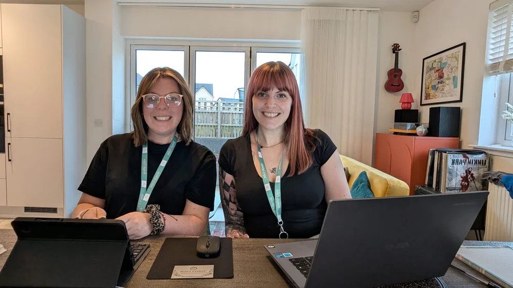 Alison and Carmen at their desk