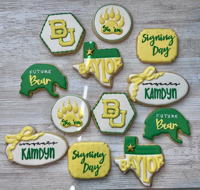 Decorative cookies with university and graduation themes, including Baylor University logs, graduation caps, and congratulatory messages for signing day and future plans.