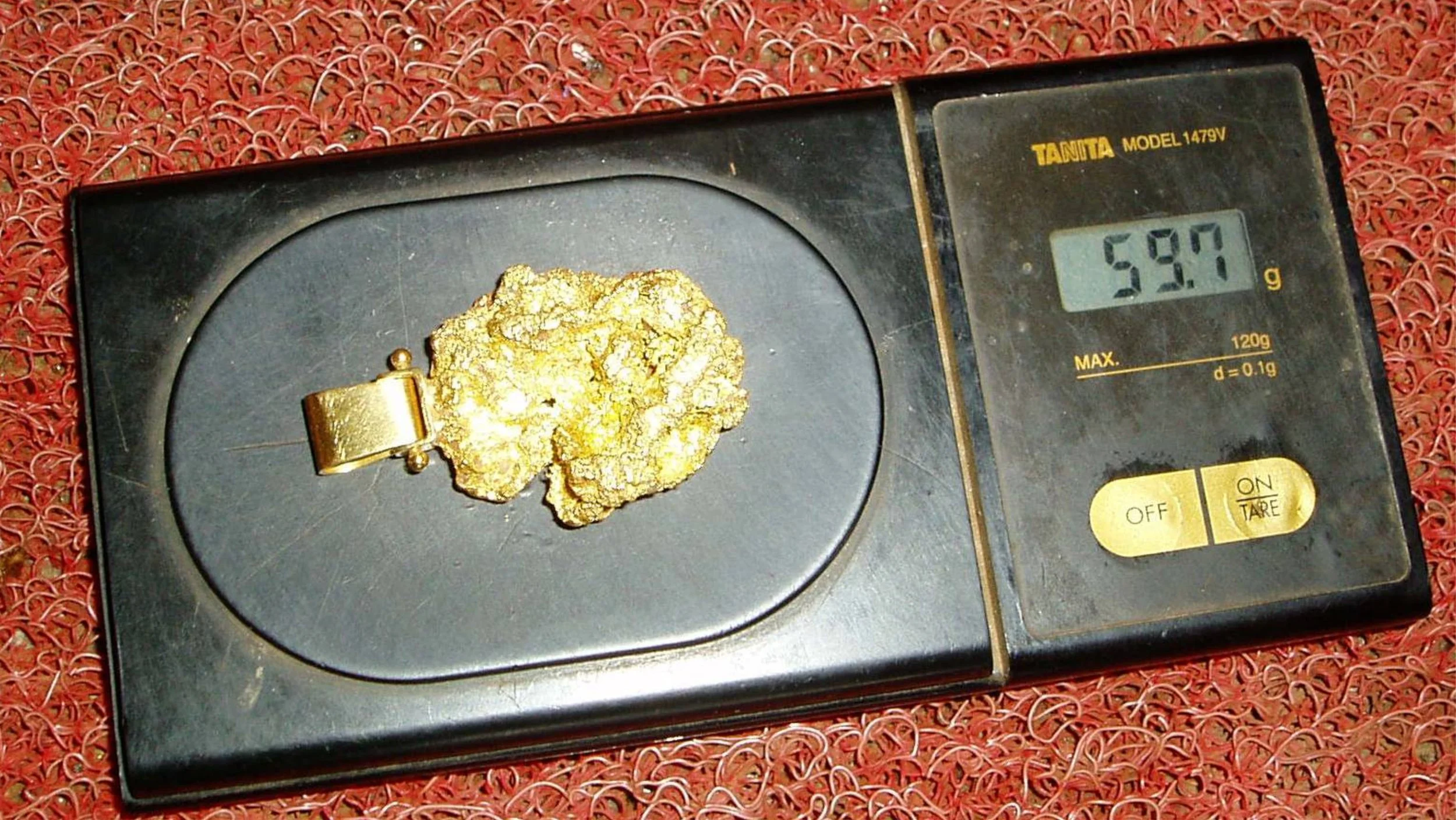 gold nugget weighing two ounces fashioned into a pendant from small scale gold miners guerimperos in Suriname jungle