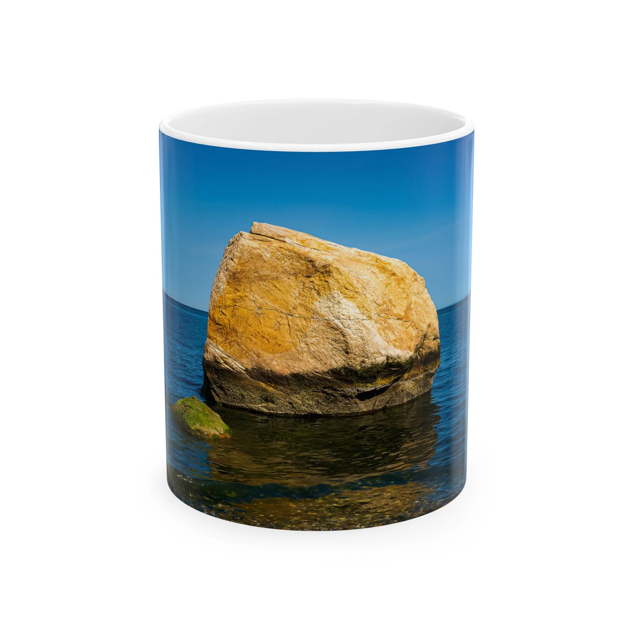 Front of Island Speaks 'Big Rock, Little Rock' 11 oz mug featuring photo of large orange and brown rock with darkened base and smaller moss covered rock with water surrounding them and blue sky in background.