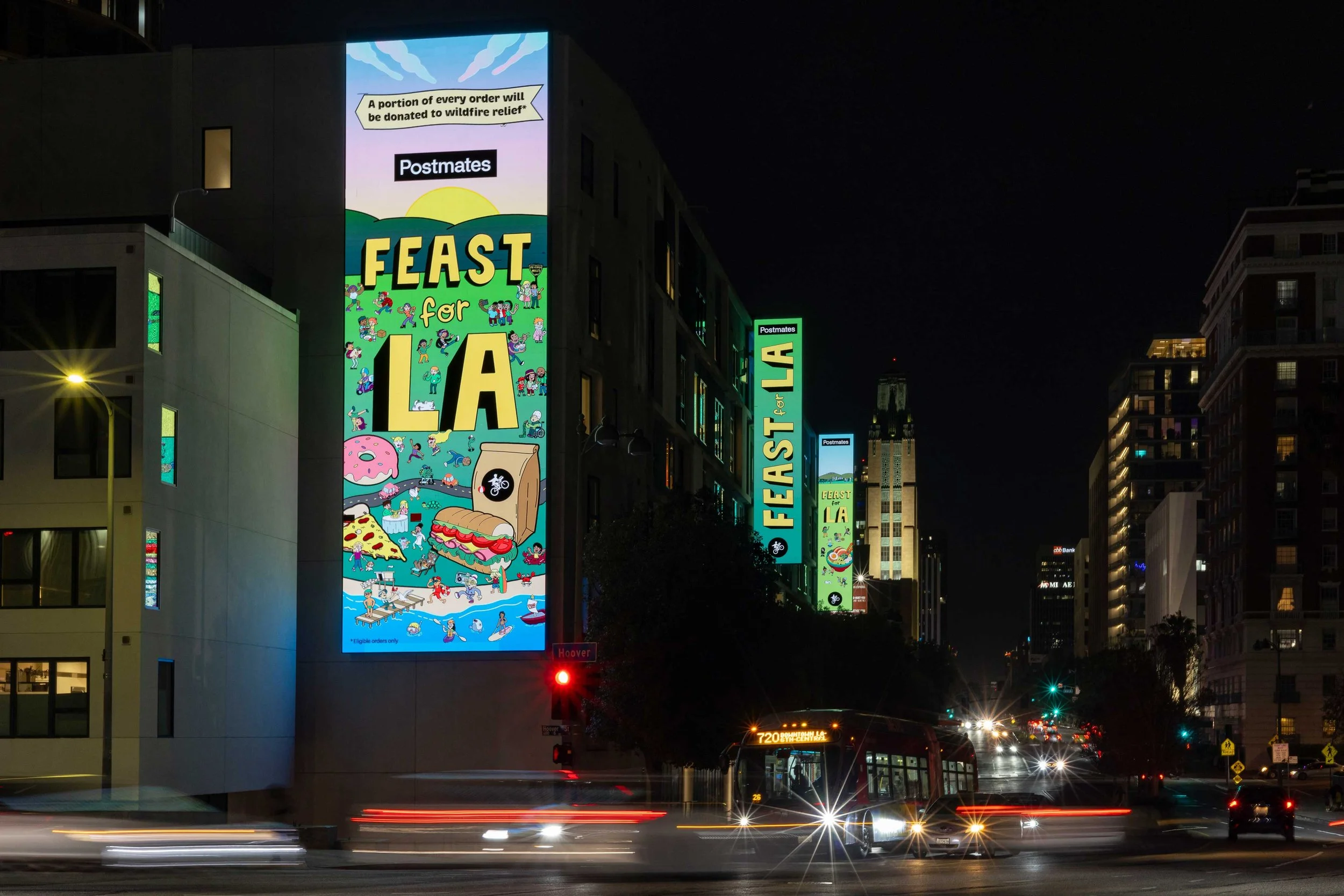 Postmates Feast For LA digital billboard on a downtown Los Angeles building at night with street light trails — OOH campaign artwork by Danvillage illustrator Daniel Sulzberg