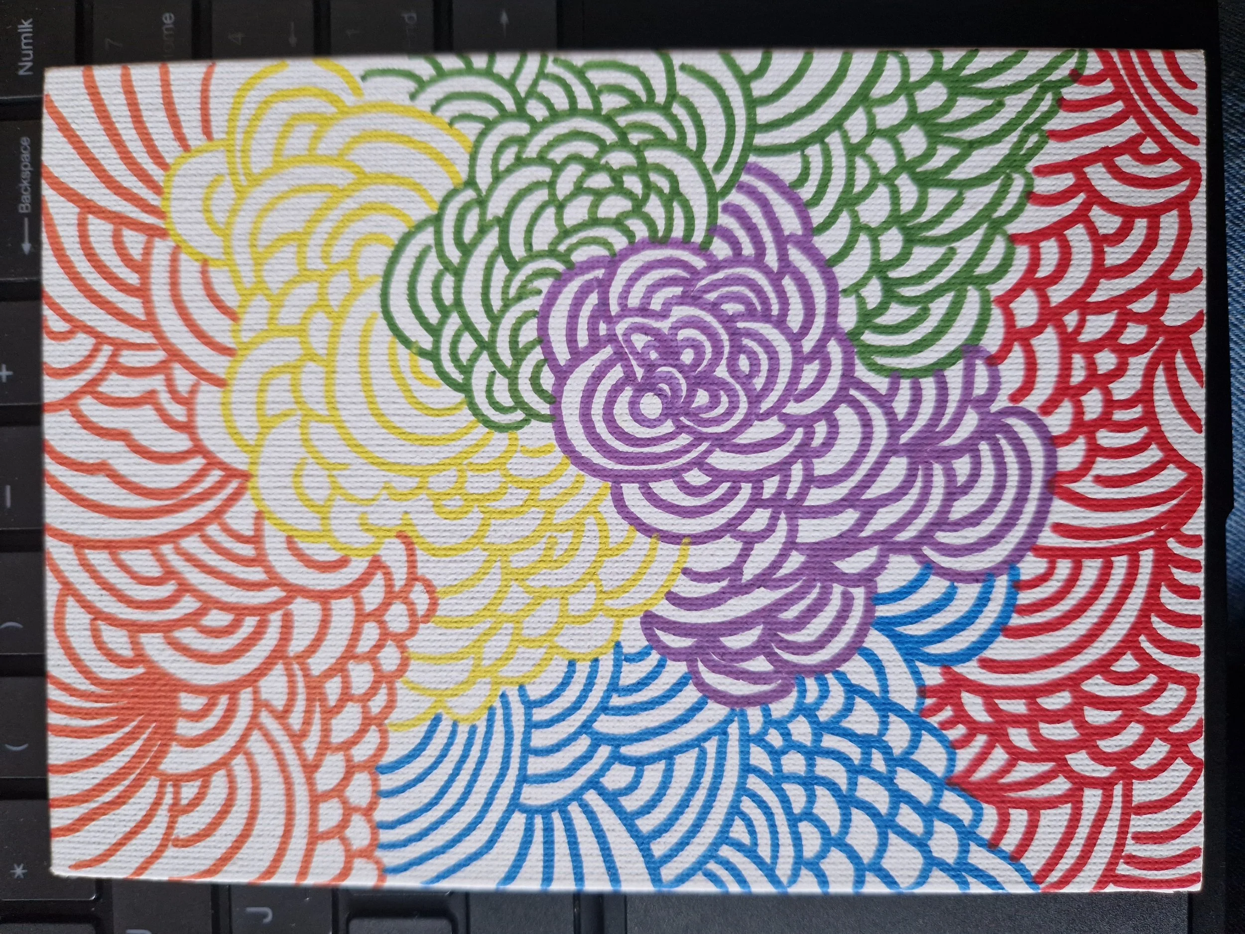 A colorful abstract pattern of overlapping, swirling lines in orange, yellow, green, purple, red, and blue on a white textured background.