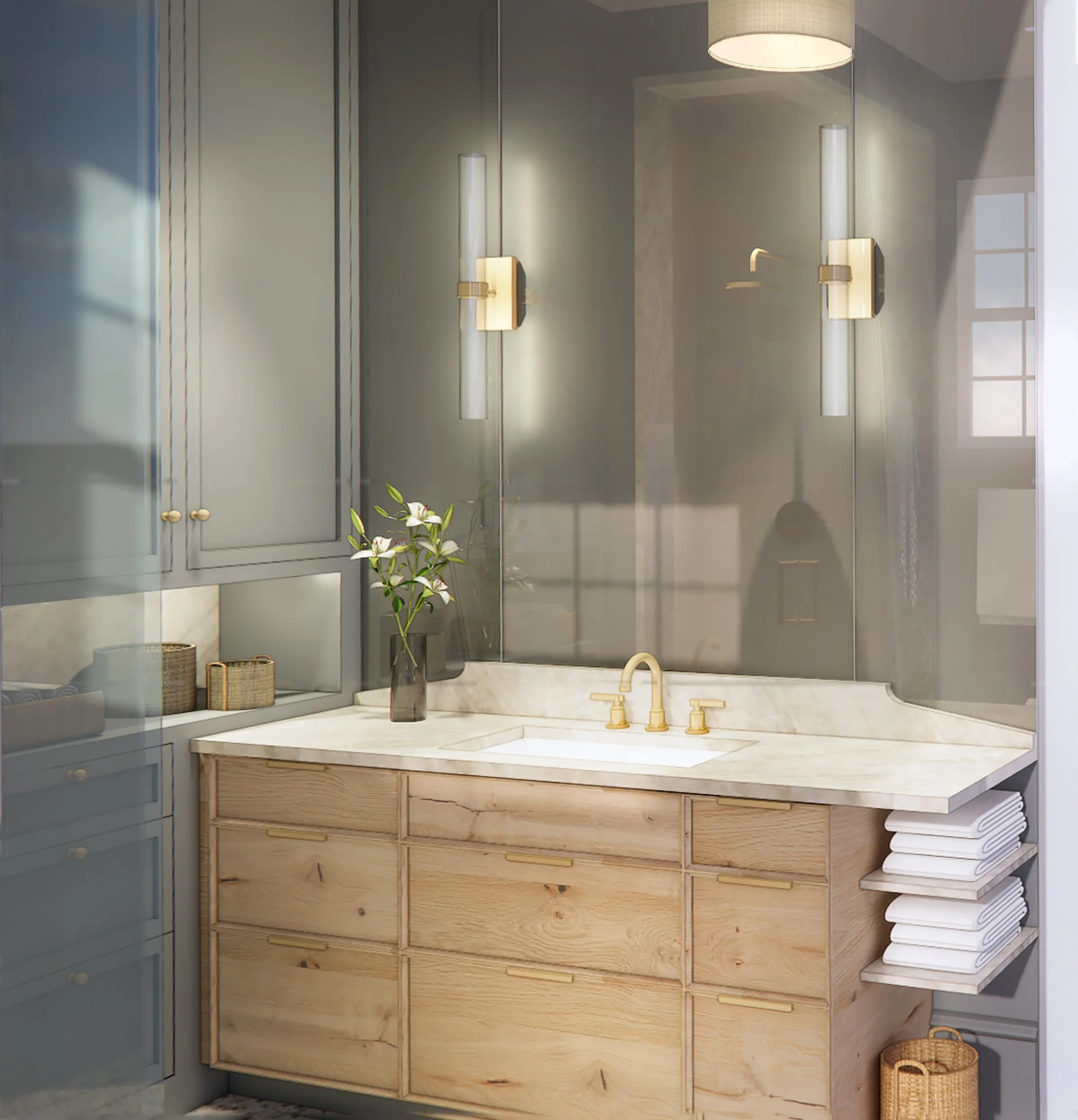 A bathroom vanity with a marble countertop, a gold faucet, and a large mirror reflecting a window. There is a dark vase with a plant and flowers on the counter. The vanity has wooden drawers and cabinets, with baskets and towels nearby.