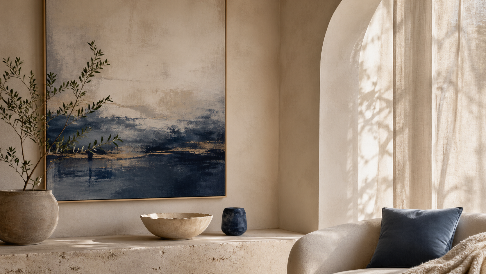 Neutral therapy office with chair, blue accent pillow, and abstract wall art