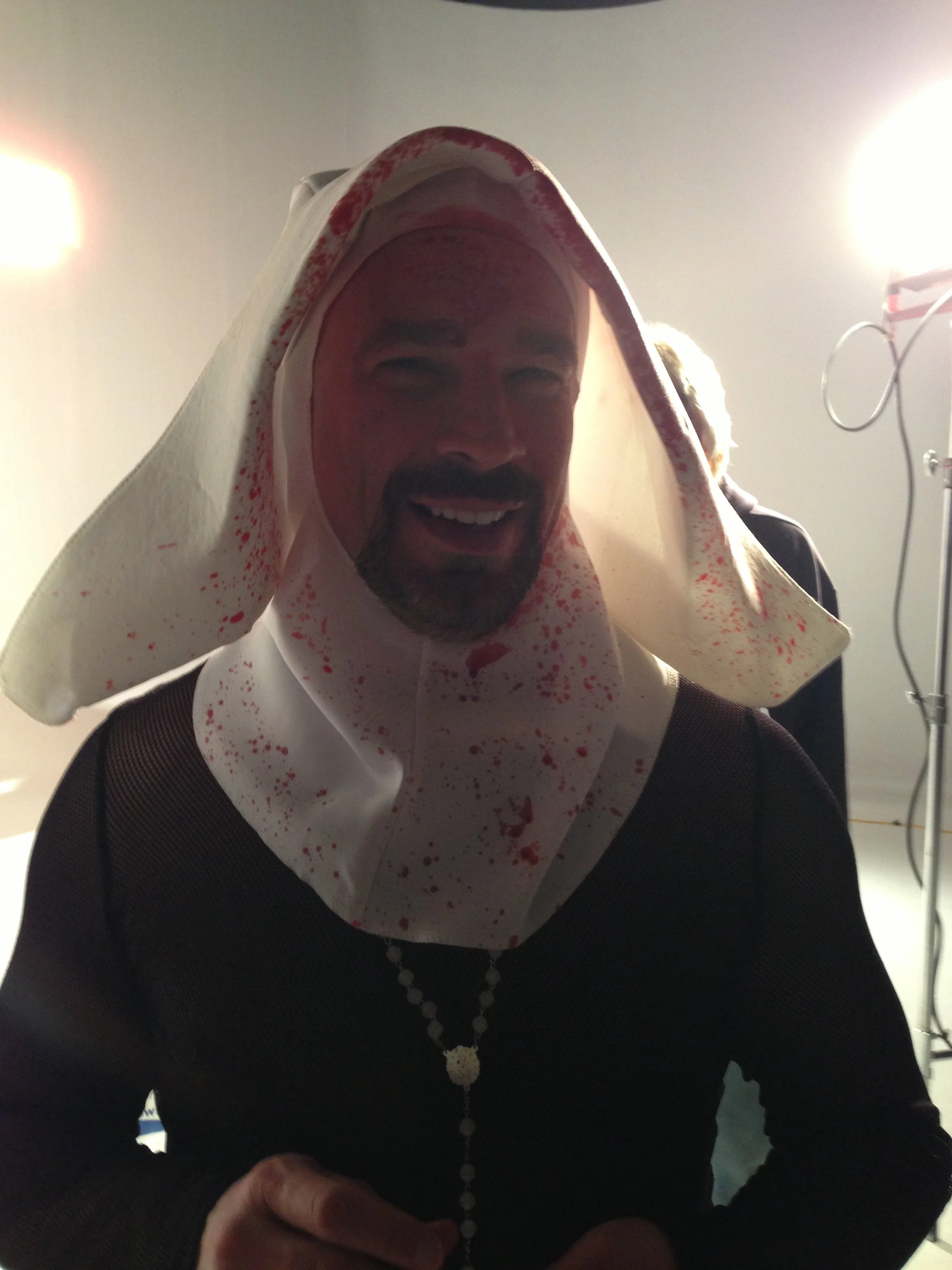 Vic Alejandro on the set of "Directors on Directing" dressed as a nun in a white habit with fake blood speckled on the habit.