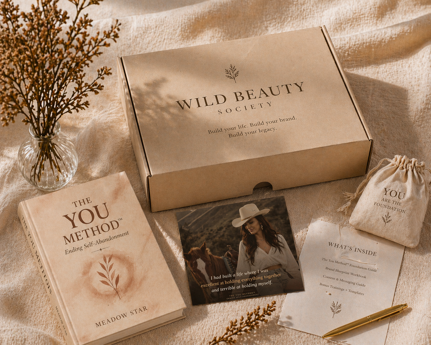 The YOU Method book by Meadow Star with Wild Beauty Society business in a box, branding kit, and lifestyle stationery in neutral aesthetic flat lay.