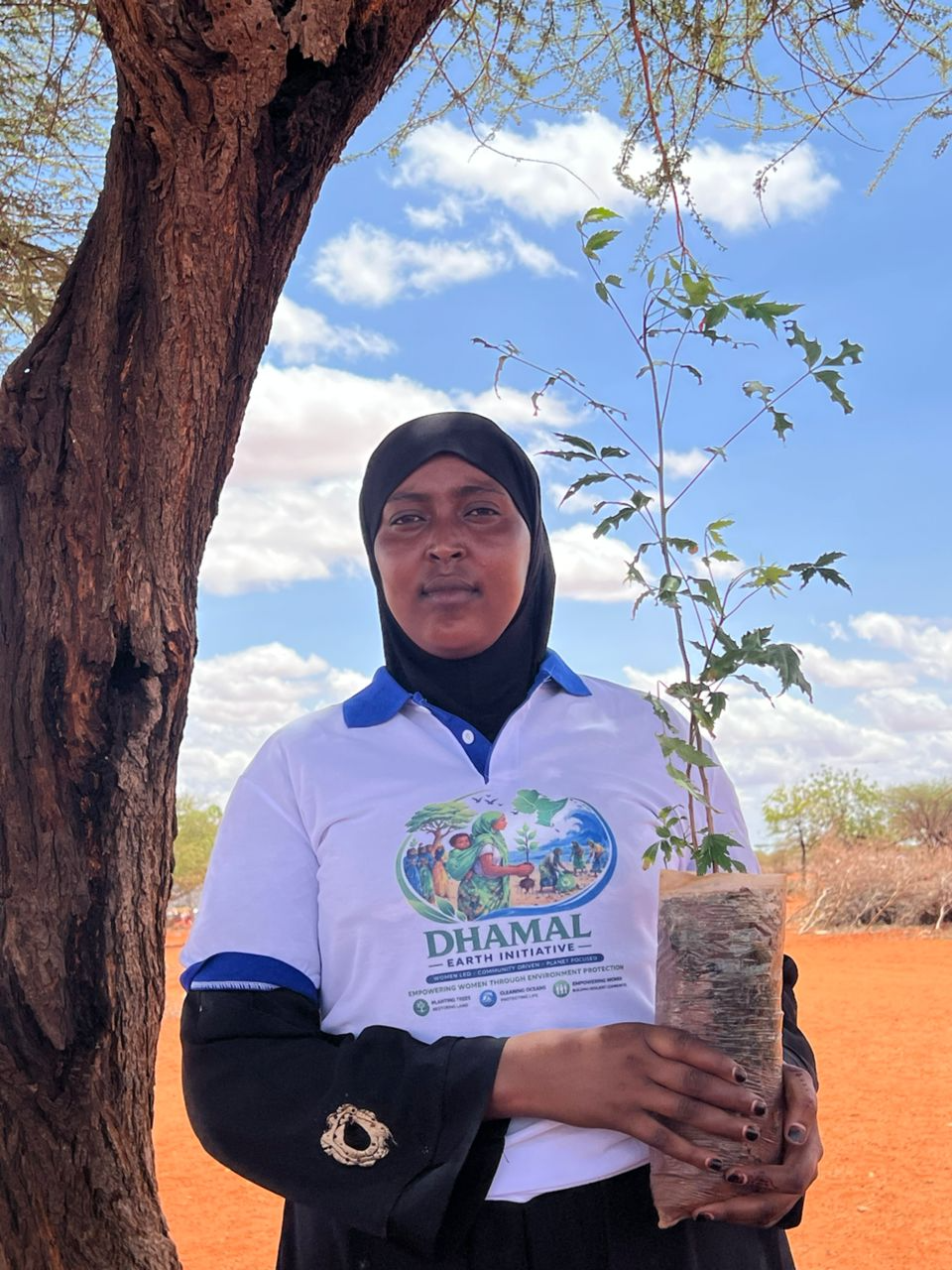 Young lady with tree seedling