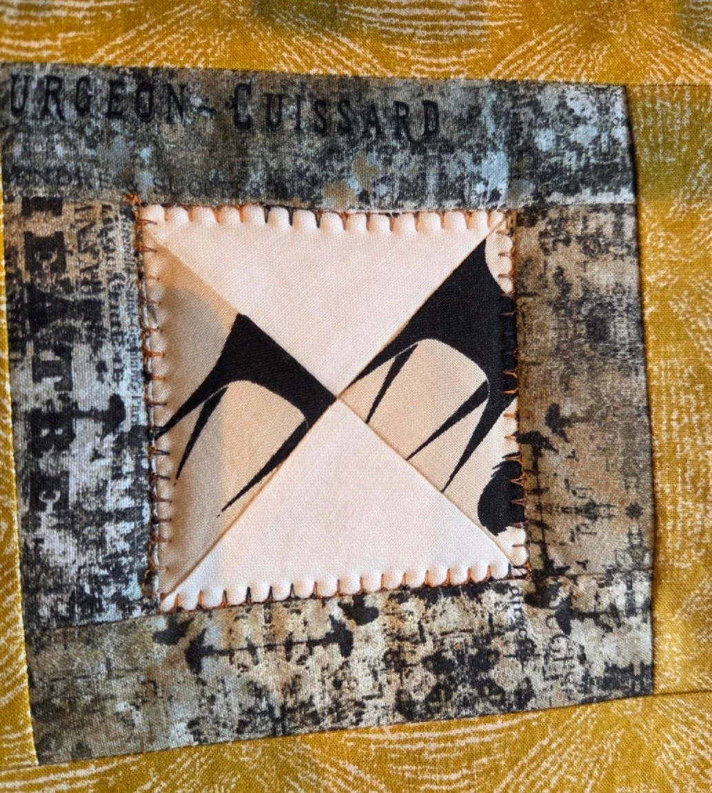 The fabric block features a black and white abstract design with stitched edges.