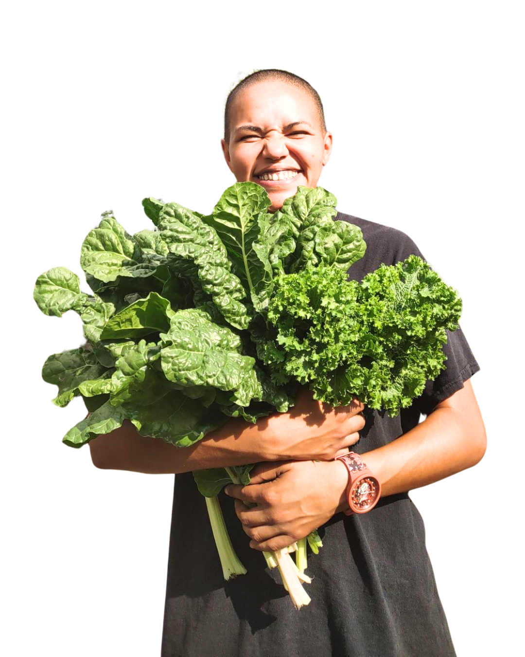 Close-up of a smiling woman with short hair outdoors, surrounded by greenery and other people.