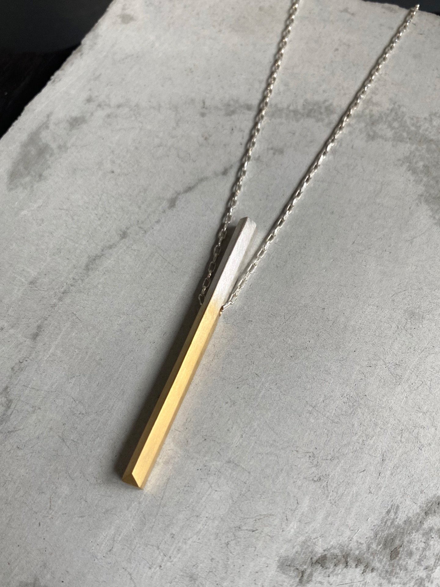 Knife Edge Pendant Necklace 🖤

A sculptural everyday piece featuring a fine adjustable anchor chain &amp; signature knife edge pendant. 
Available to pre-order in two limited finishes (blackened gradient silver or 18ct gold dipped silver). 
Made in 