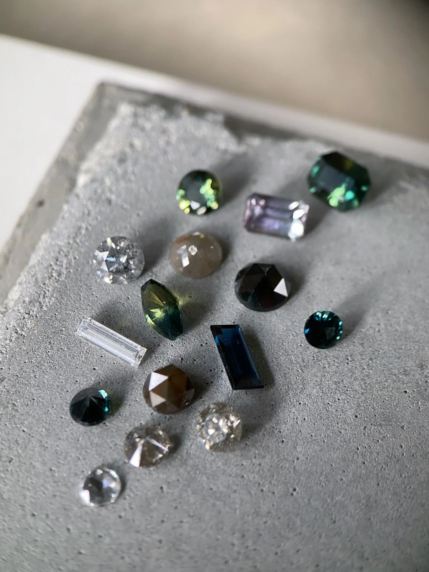 A collection of handpicked natural gemstones, gathered over time.

Australian sapphires, tourmalines &amp; diamonds in shades of white, grey, black and green - each selected for its unique character, colour &amp; cut. Most are one of a kind and will 