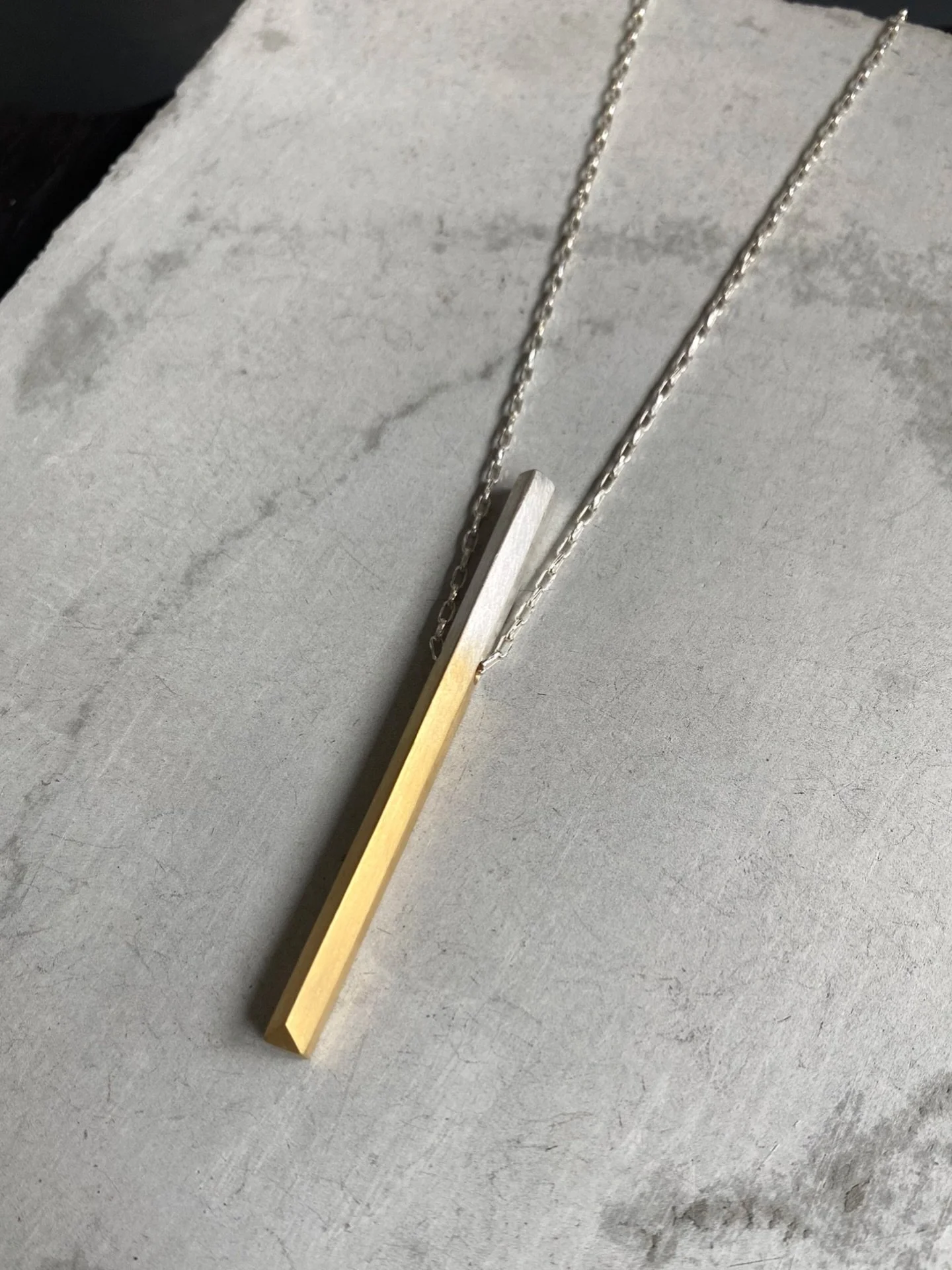Knife Edge Pendant Necklace 🖤

A sculptural everyday piece featuring a fine adjustable anchor chain &amp; signature knife edge pendant. 
Available to pre-order in two limited finishes (blackened gradient silver or 18ct gold dipped silver). 
Made in 
