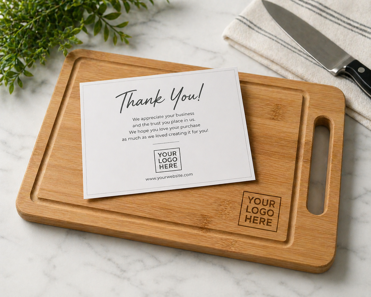 Thank you note on a white paper placed on a wooden cutting board on a marble countertop, with a knife and a cloth in the background.