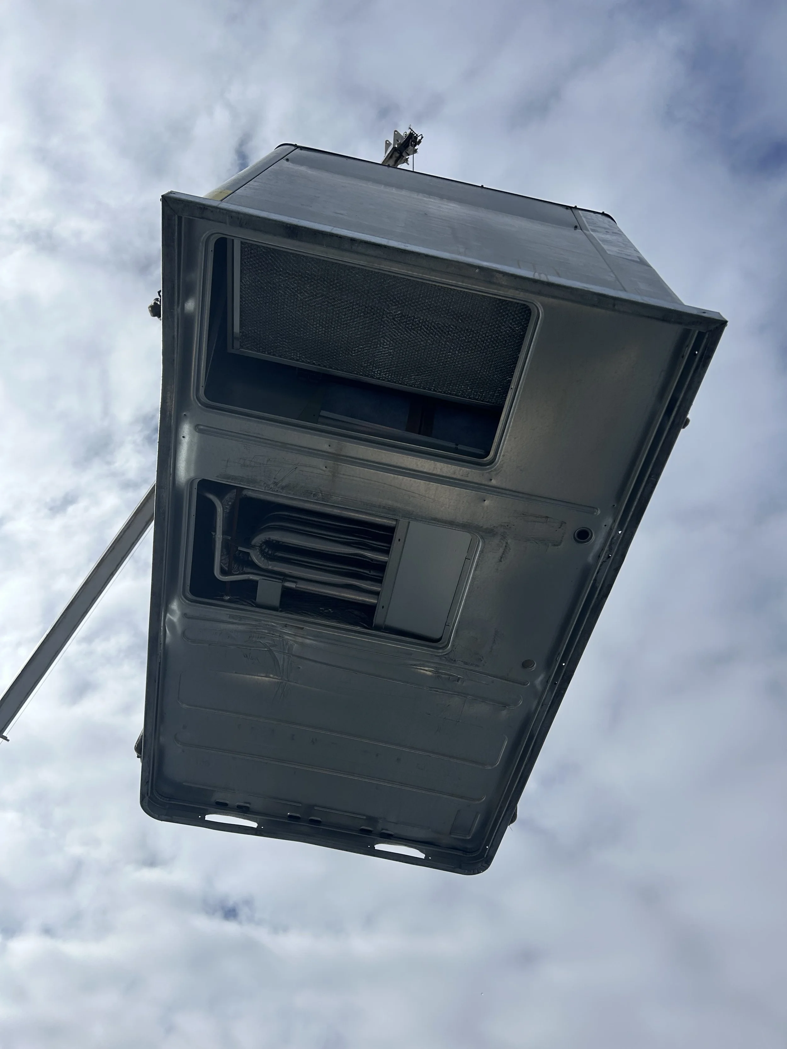 Upward view of a 10-ton HVAC rooftop unit.